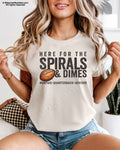 Female model wearing an ivory Comfort Colors football mom shirt featuring the "Here for the Spirals & Dimes" quarterback design.