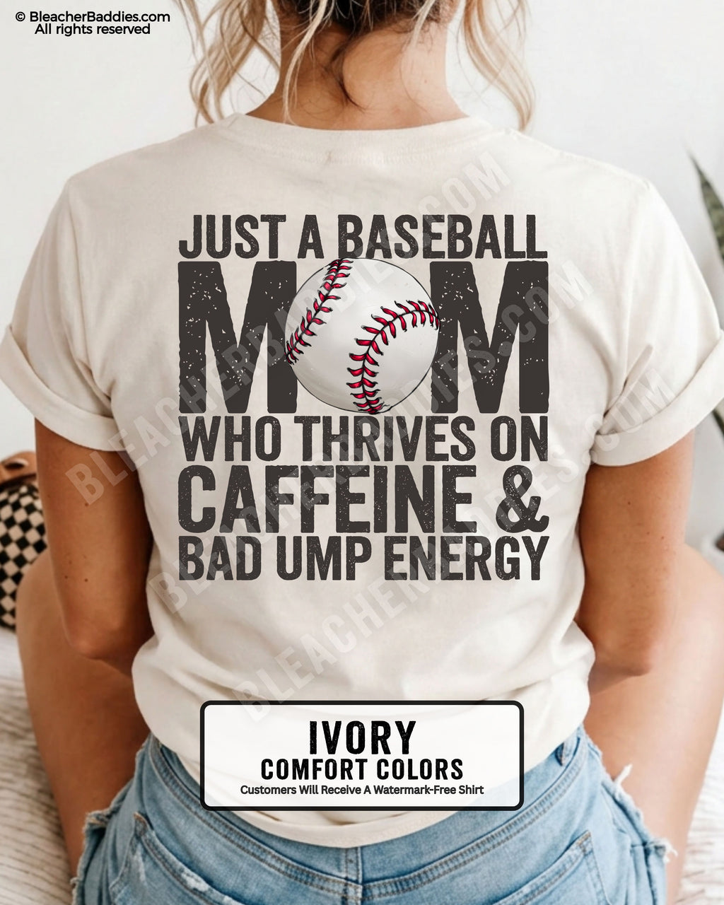 Ivory Comfort Colors baseball mom shirt featuring distressed back graphic reading “Just a Baseball Mom Who Thrives on Caffeine & Bad Ump Energy” with oversized typography and baseball illustration