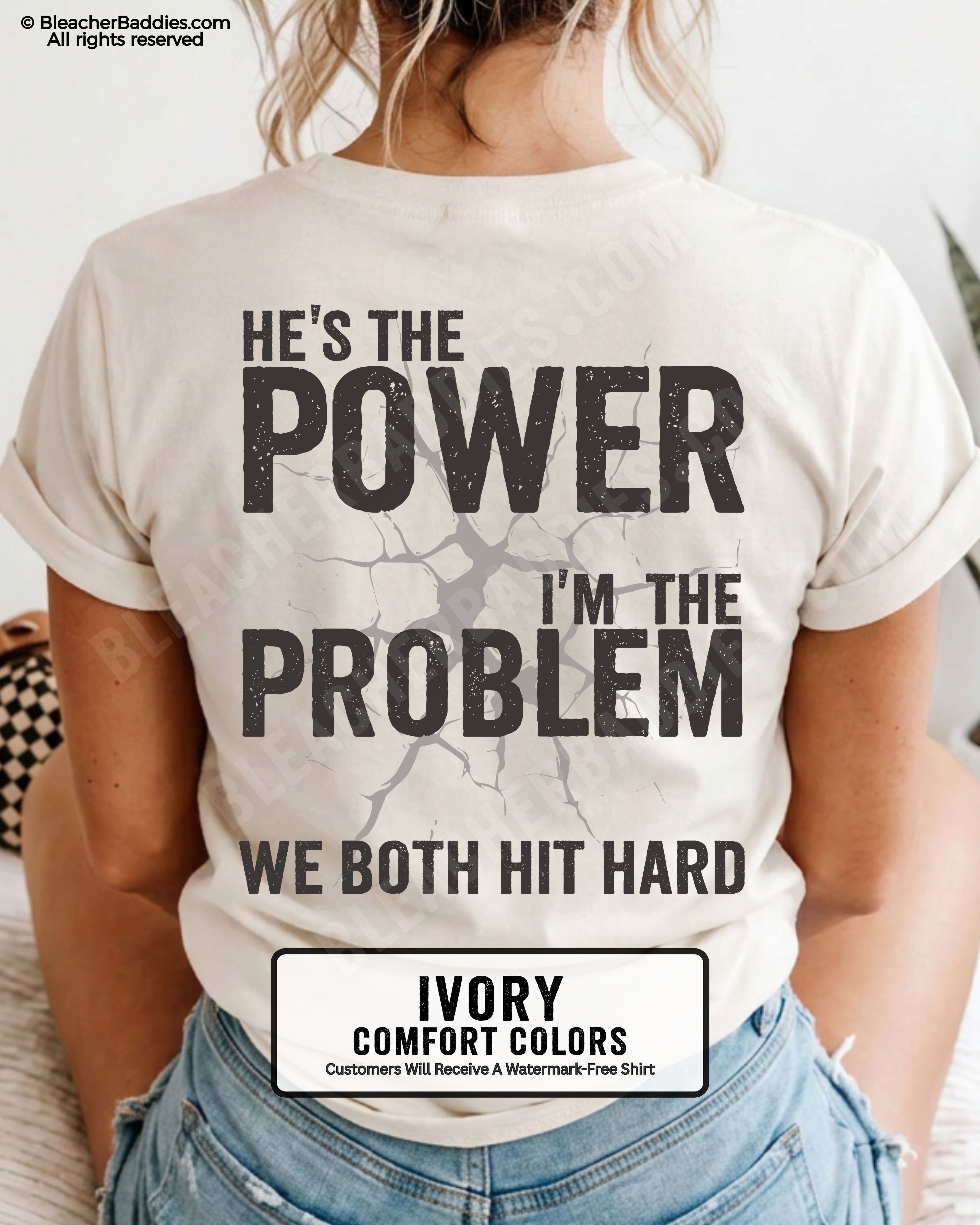Back view of ivory Comfort Colors football mom game day shirt reading “He’s the Power I’m the Problem We Both Hit Hard,” close-up fit on woman wearing denim shorts