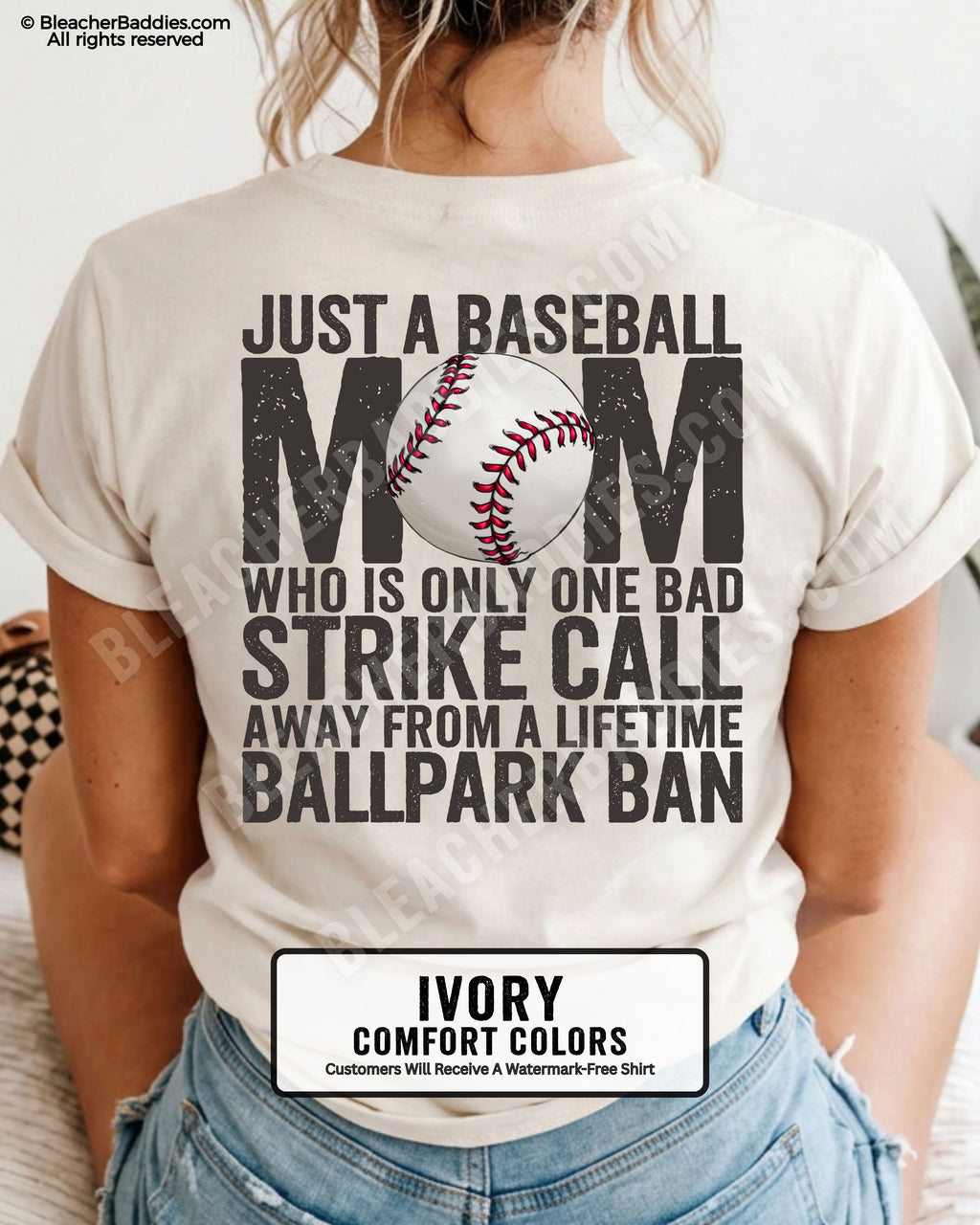 Ivory Comfort Colors game day shirt worn by woman showing distressed back graphic reading “Just a Baseball Mom Who Is Only One Bad Strike Call Away From A Lifetime Ballpark Ban” with baseball illustration layered over MOM  text