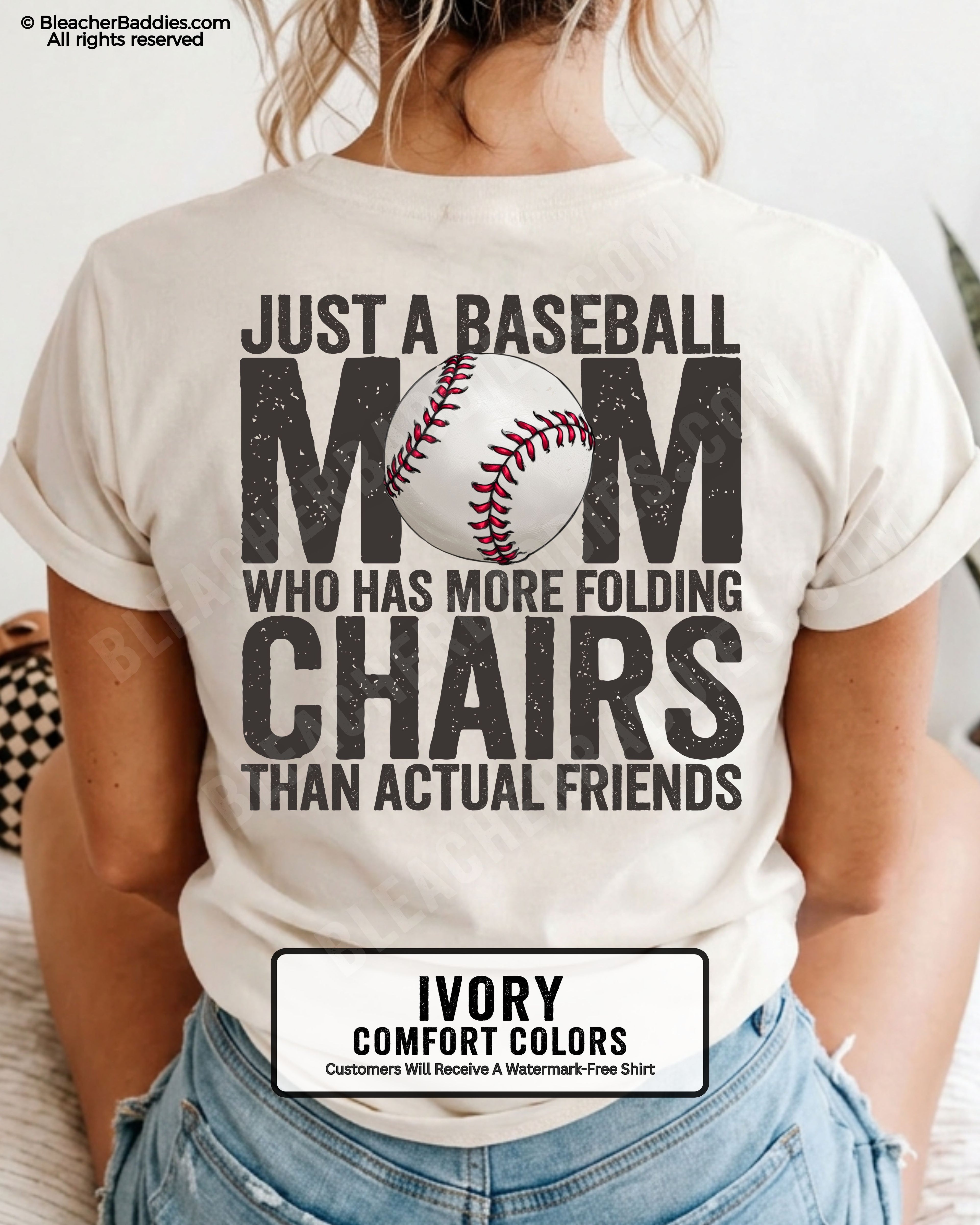 Ivory Comfort Colors baseball mom graphic tee featuring distressed black back design reading “Just a baseball mom who has more folding chairs than actual friends” with baseball illustration in MOM