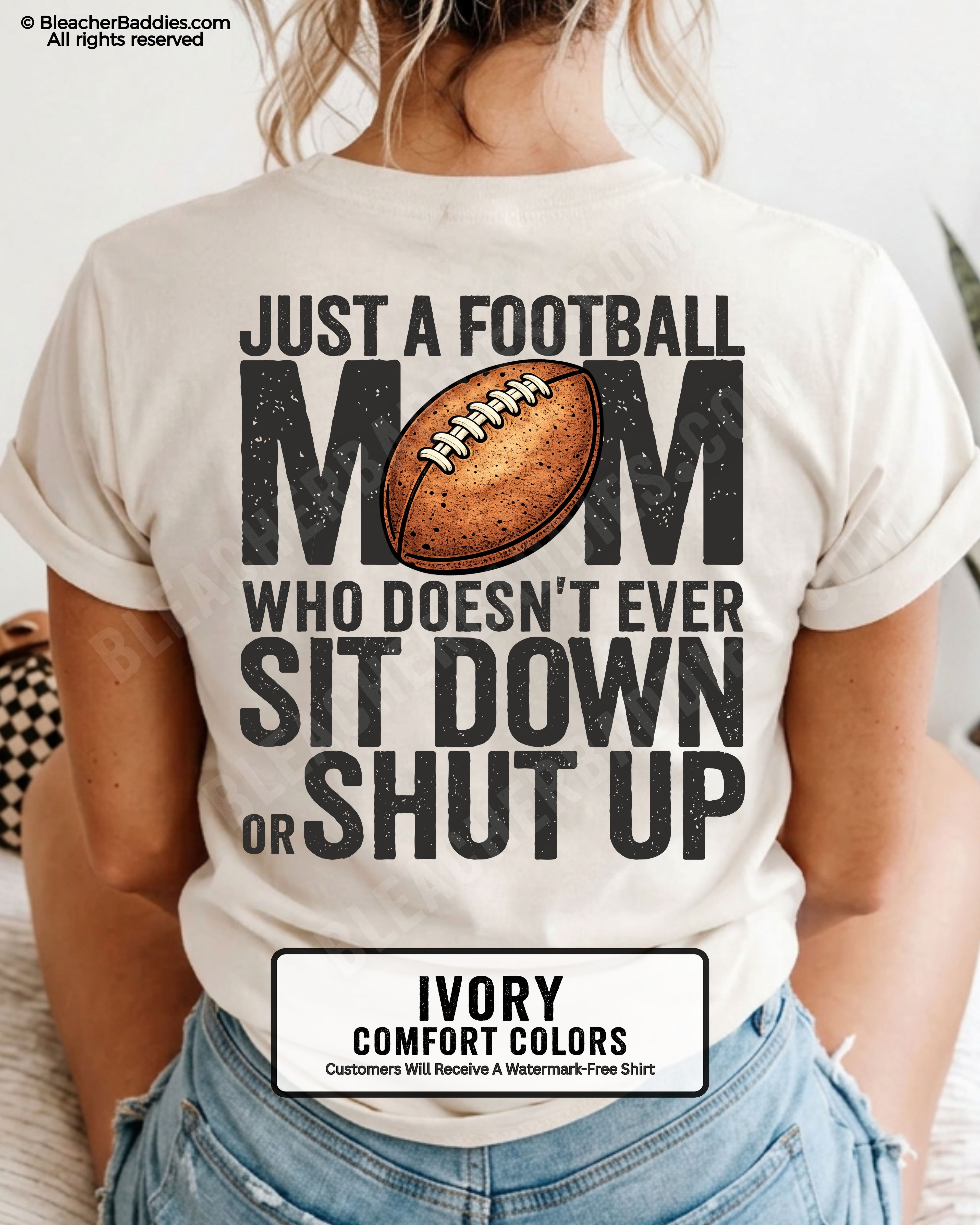 Ivory Comfort Colors t-shirt shown from back with oversized graphic text “Just a Football Mom Who Doesn’t Ever Sit Down or Shut Up” and football illustration