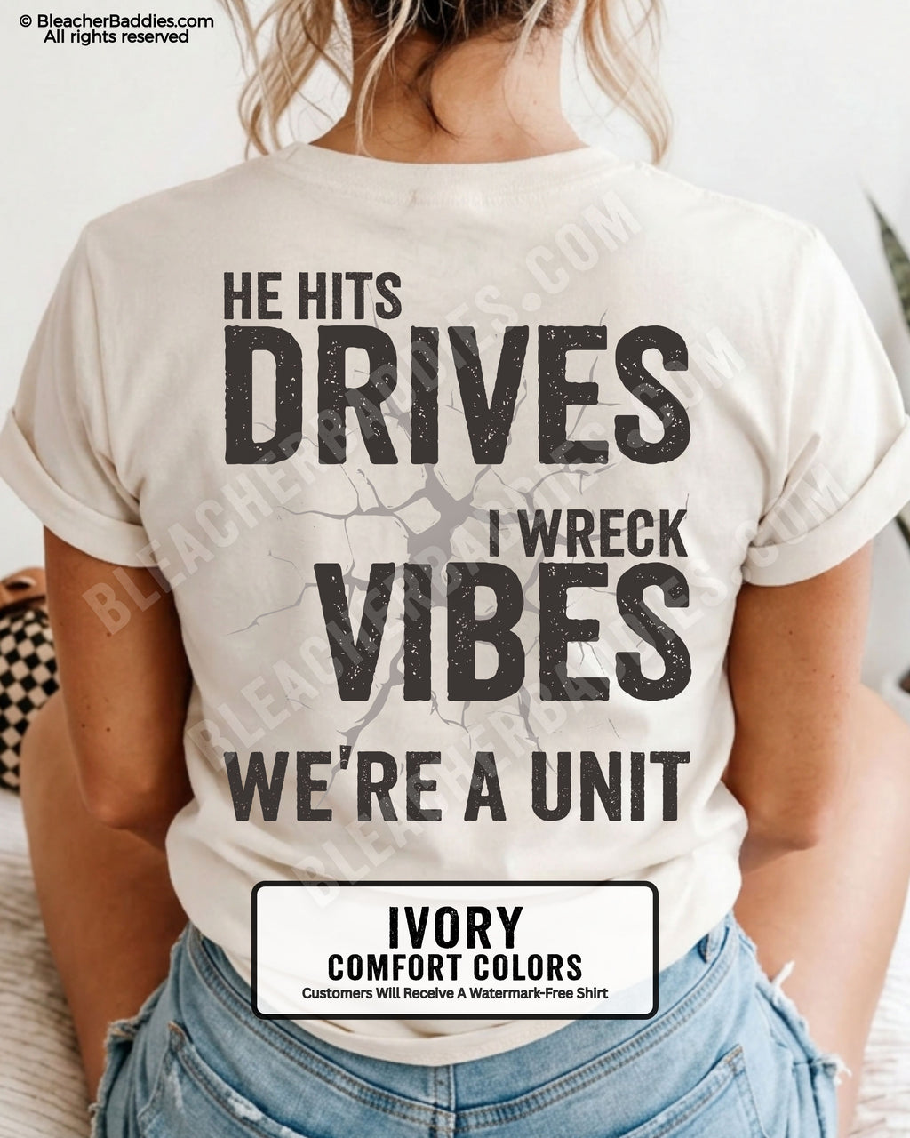Ivory Comfort Colors baseball mom shirt featuring oversized distressed back graphic reading “He Hits Drives I Wreck Vibes We’re A Unit” with cracked background detail and vintage sports mom aesthetic.