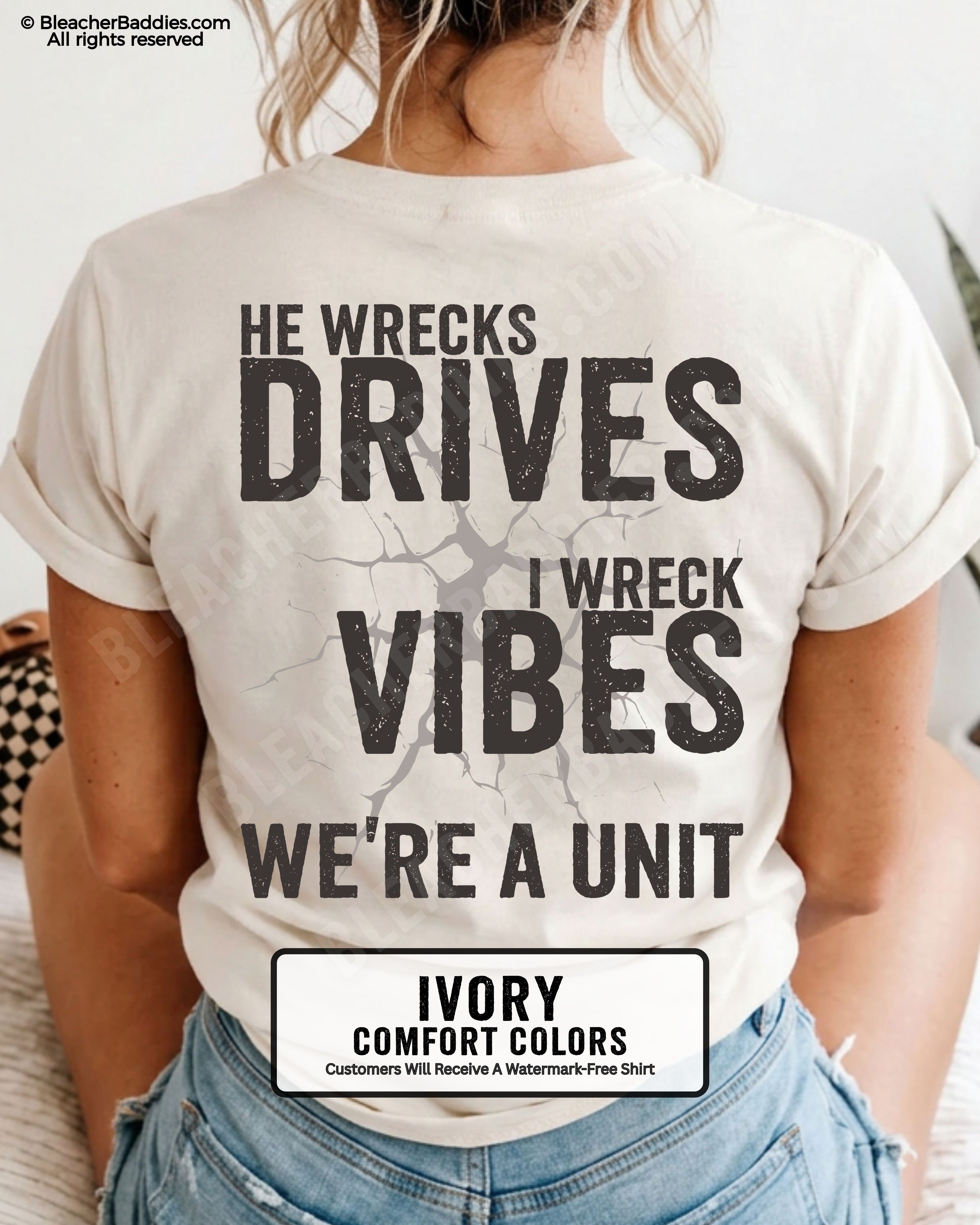 Woman wearing an ivory Comfort Colors t-shirt shown from the back featuring a large distressed black graphic that reads “He Wrecks Drives I Wreck Vibes We’re a Unit.”