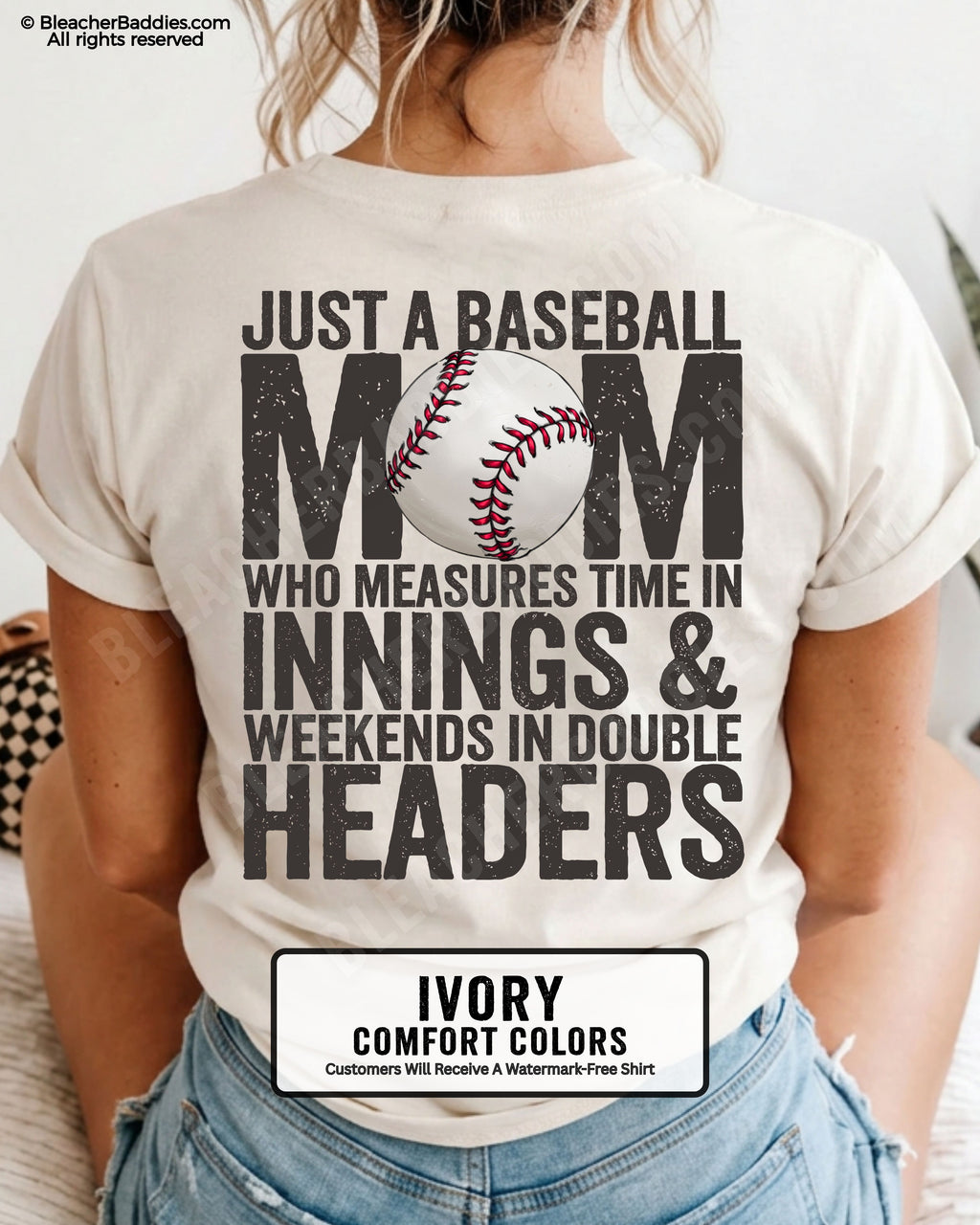 Ivory Comfort Colors game day shirt worn by woman showing distressed back graphic reading “Just a Baseball Mom Who Measures Time in Innings & Weekends in Double Headers” with baseball illustration over MOM text
