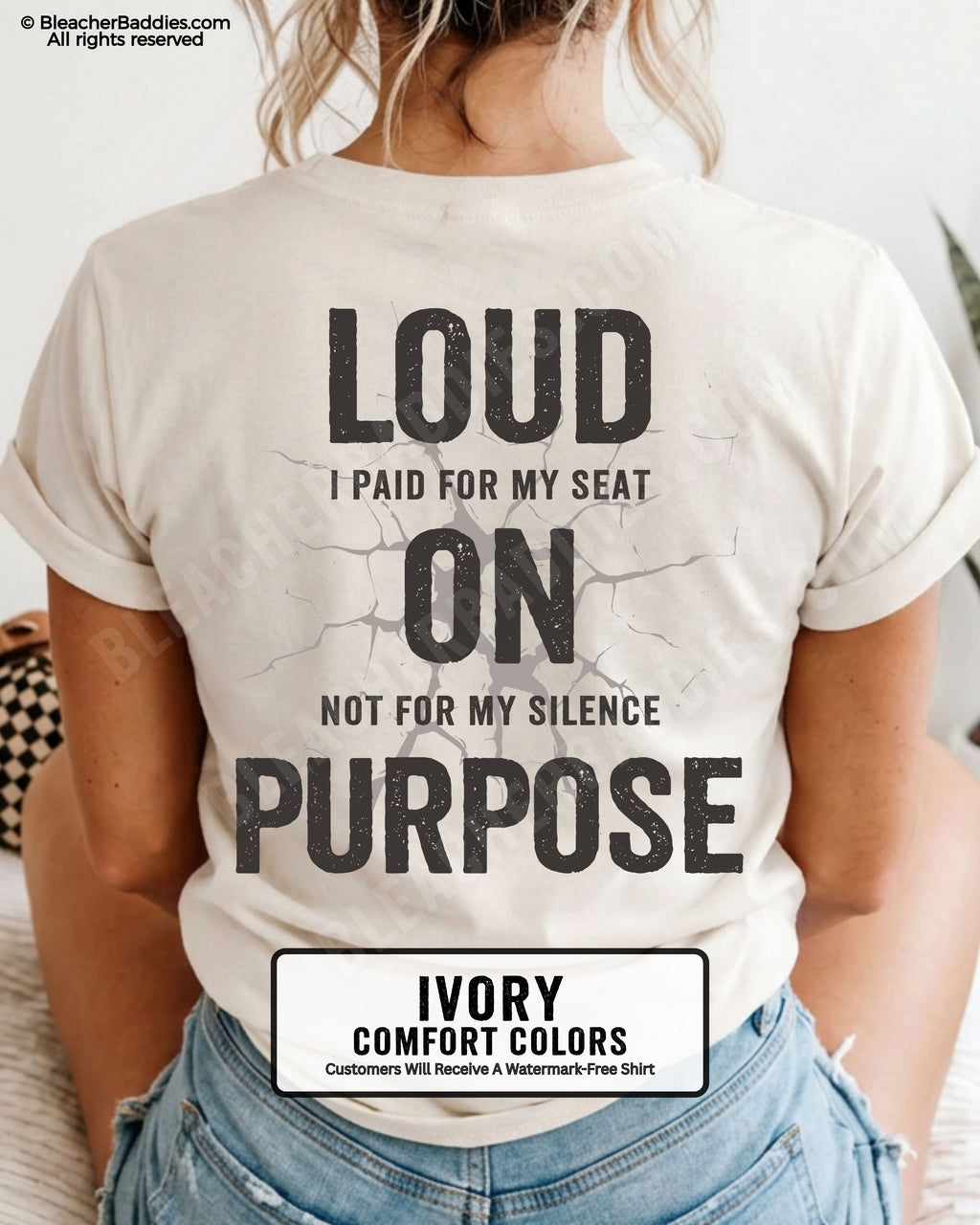 Woman wearing an ivory Comfort Colors t-shirt shown from the back featuring a large distressed black graphic that reads “Loud I Paid for My Seat On Purpose Not For My Silence” with a cracked texture effect.