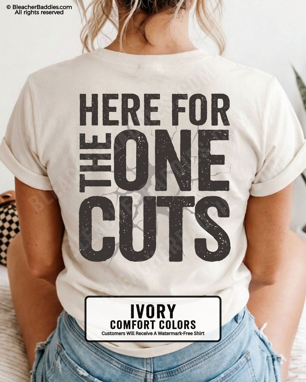 close-up back view of ivory comfort colors football mom game day shirt with “here for the one cuts” design printed on the back