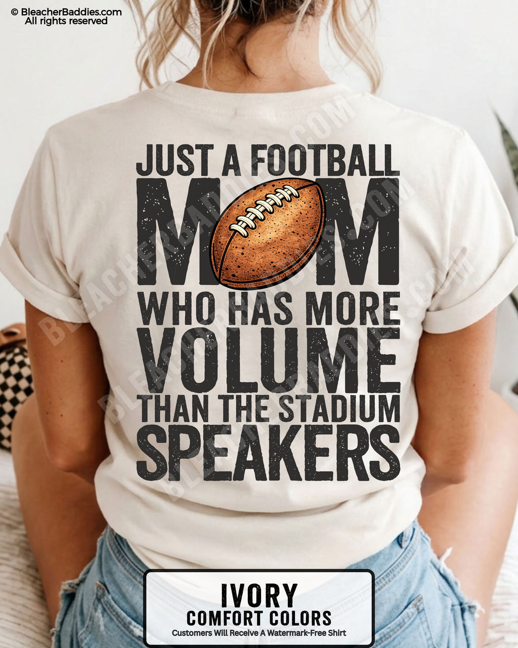 Ivory Comfort Colors t-shirt worn by woman showing back graphic reading “Just a football mom who has more volume than the stadium speakers” with football illustration