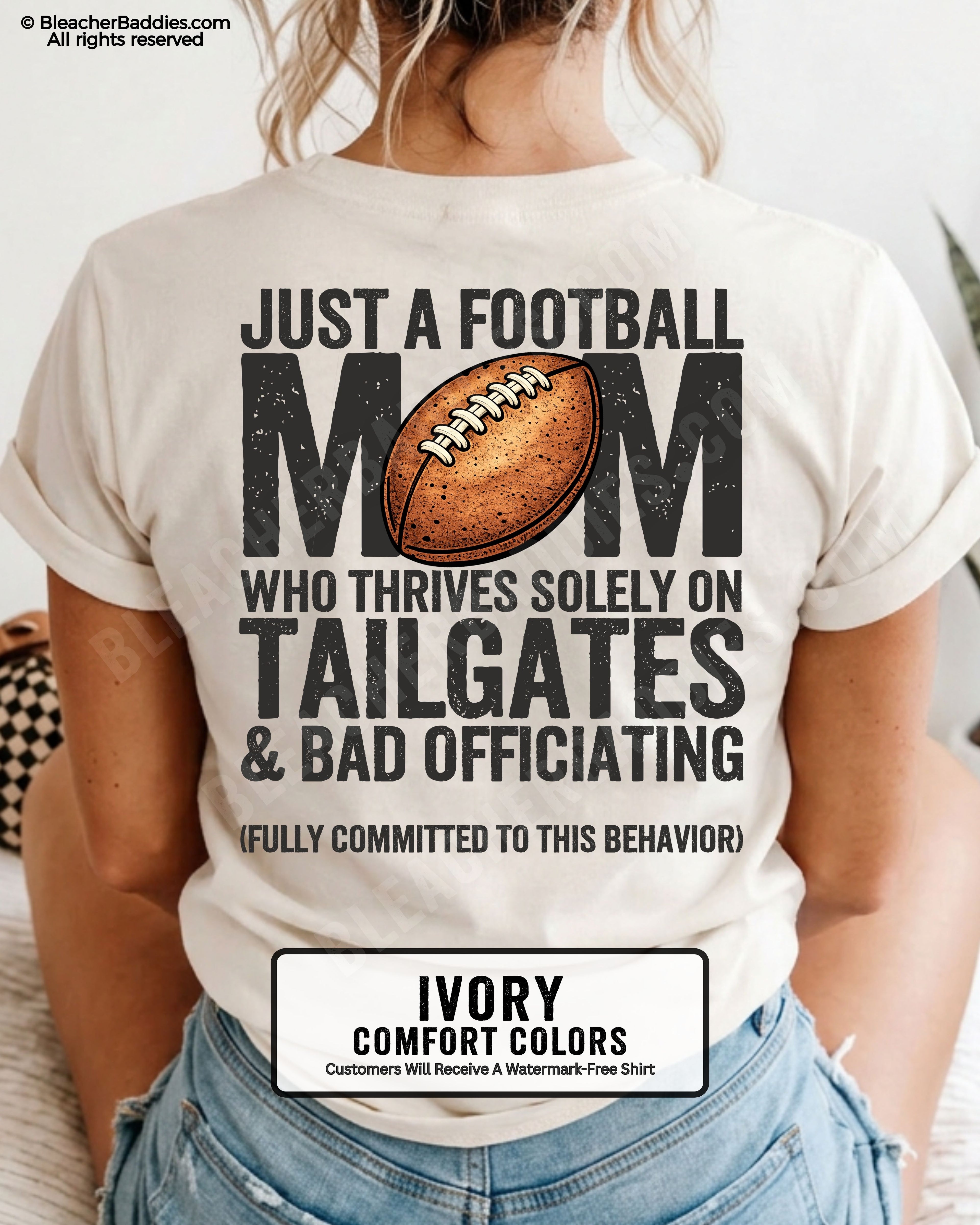 Football mom game day shirt worn by a model on a ivory Comfort Colors tee, featuring a back graphic that says, “Just a football mom who thrives solely on tailgates & bad officiating (fully committed to this behavior).”