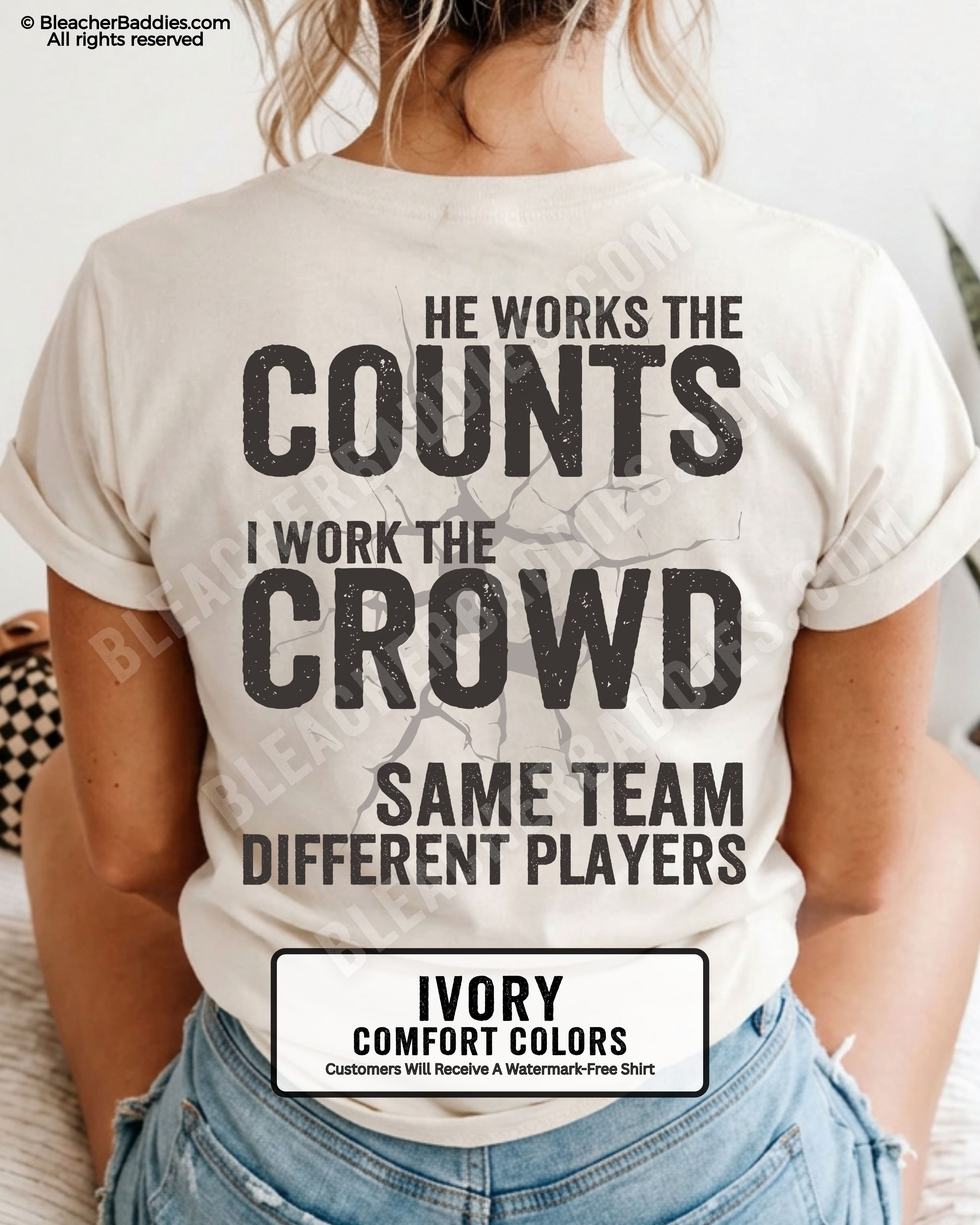 Ivory baseball mom graphic tee with distressed oversized lettering reading “He Works The Counts I Work The Crowd Same Team Different Players” across the back