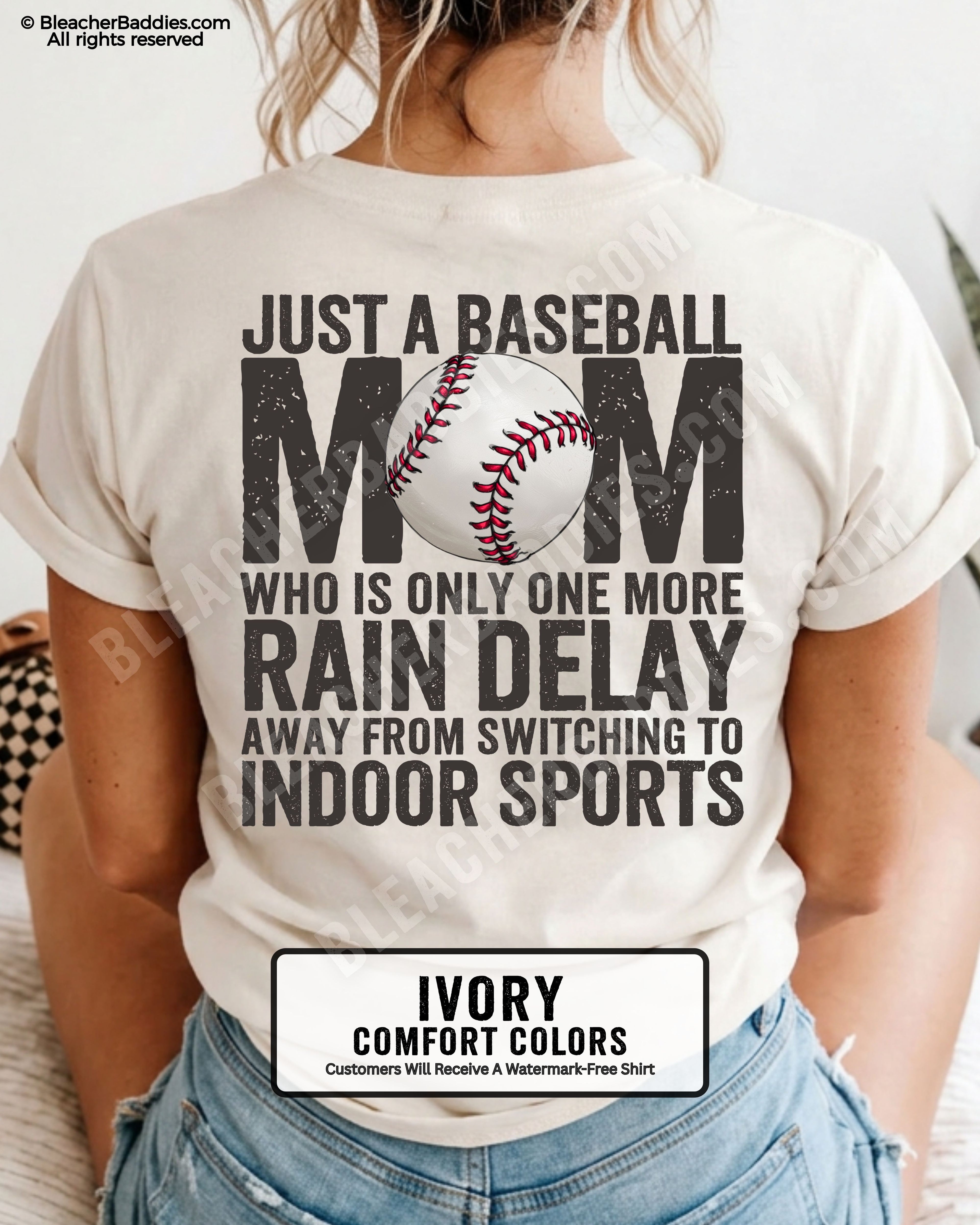 Ivory Comfort Colors game day shirt worn by woman showing distressed back graphic reading “Just a Baseball Mom Who Is Only One More Rain Delay Away From Switching To Indoor Sports” with baseball illustration over MOM text