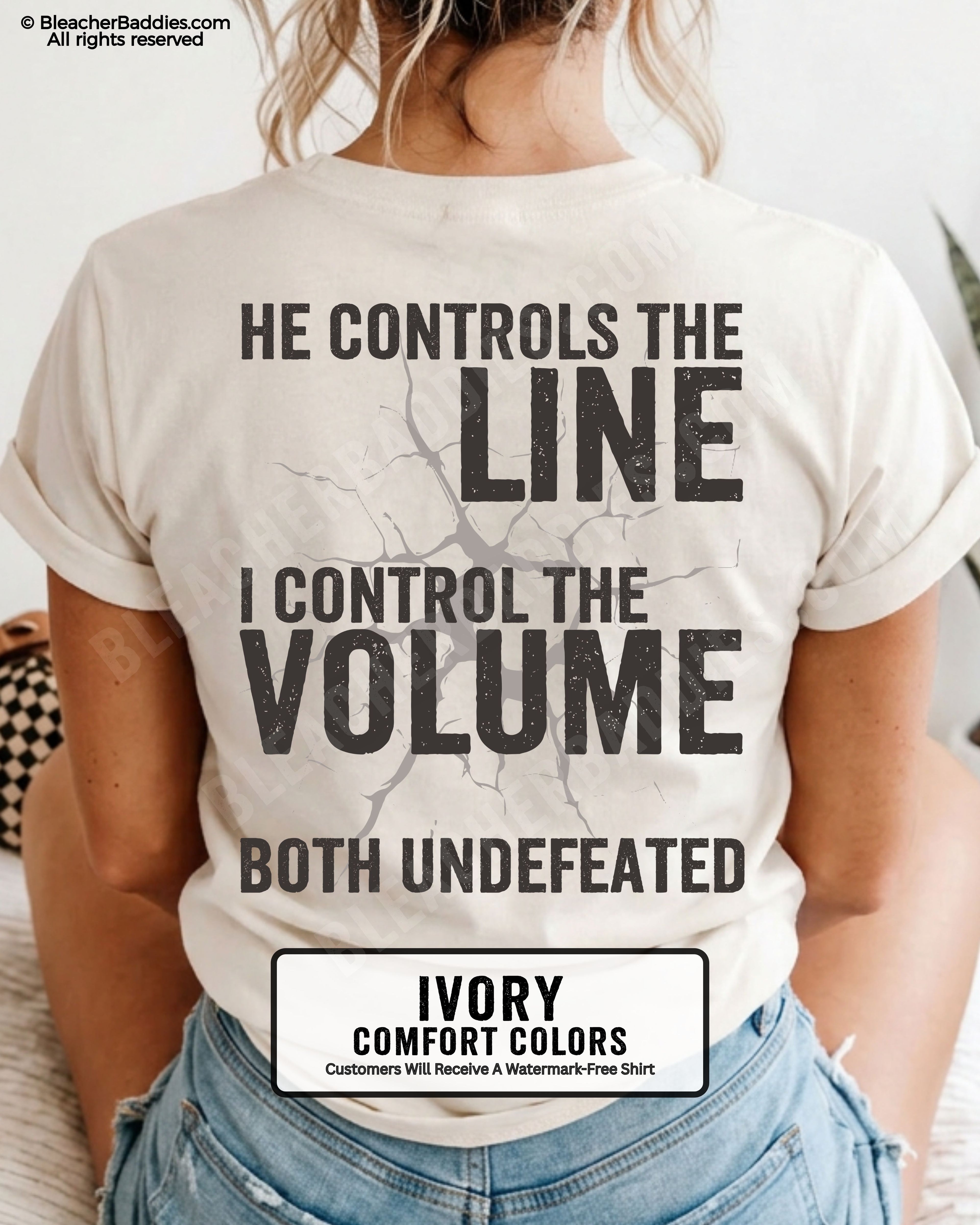 Back view of woman wearing IVORY Comfort Colors football mom game day shirt featuring “He Controls the Line I Control the Volume Both Undefeated” bold graphic design
