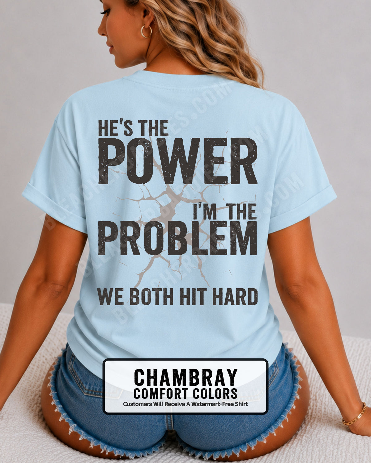 Back view of chambray blue Comfort Colors football mom game day shirt reading “He’s the Power I’m the Problem We Both Hit Hard,” close-up fit on woman wearing denim shorts