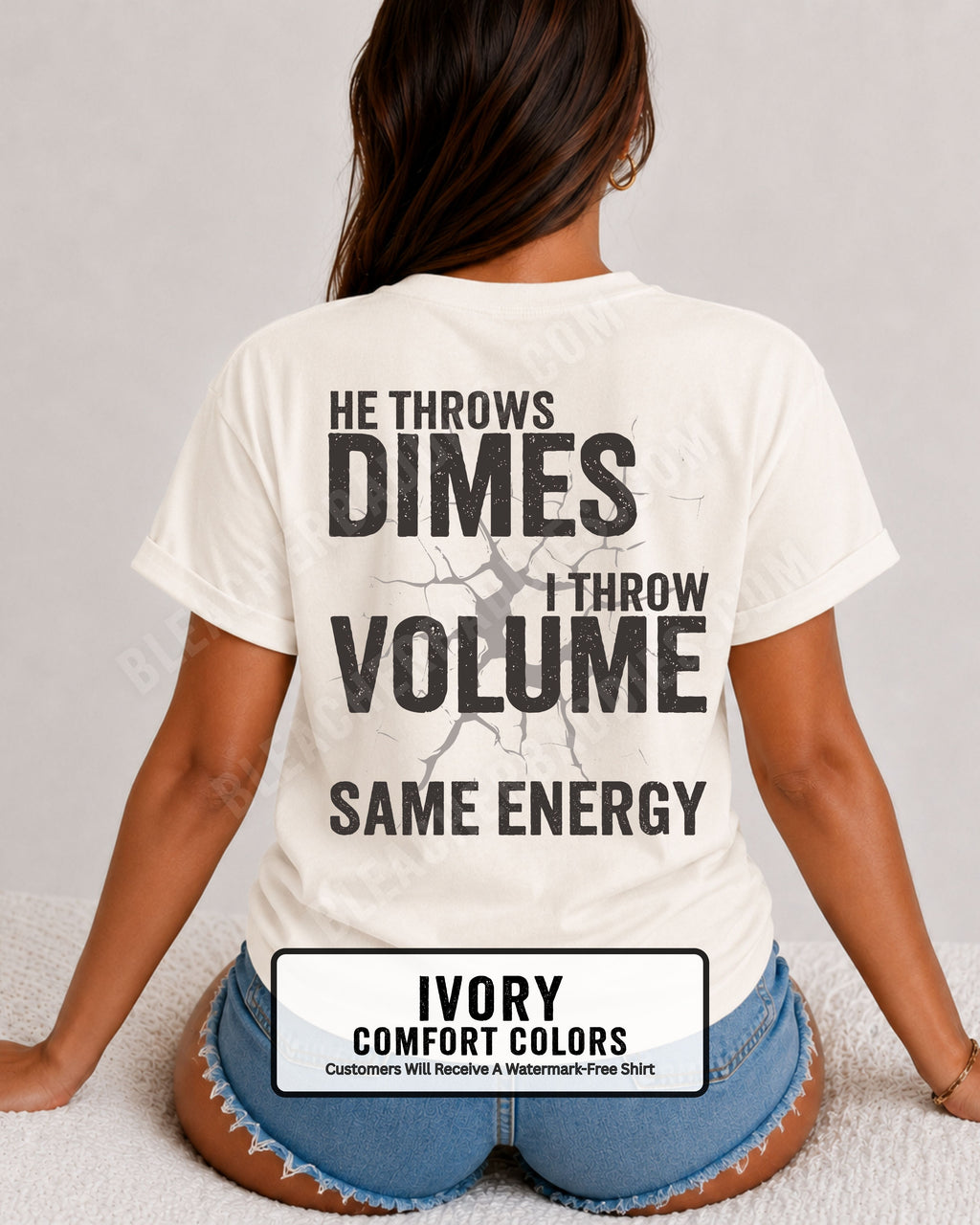 Back view of woman wearing ivory Comfort Colors t-shirt mockup showing large distressed text “He Throws Dimes I Throw Volume Same Energy” centered on the back design. Quarterback mom shirt. Football mom shirt.