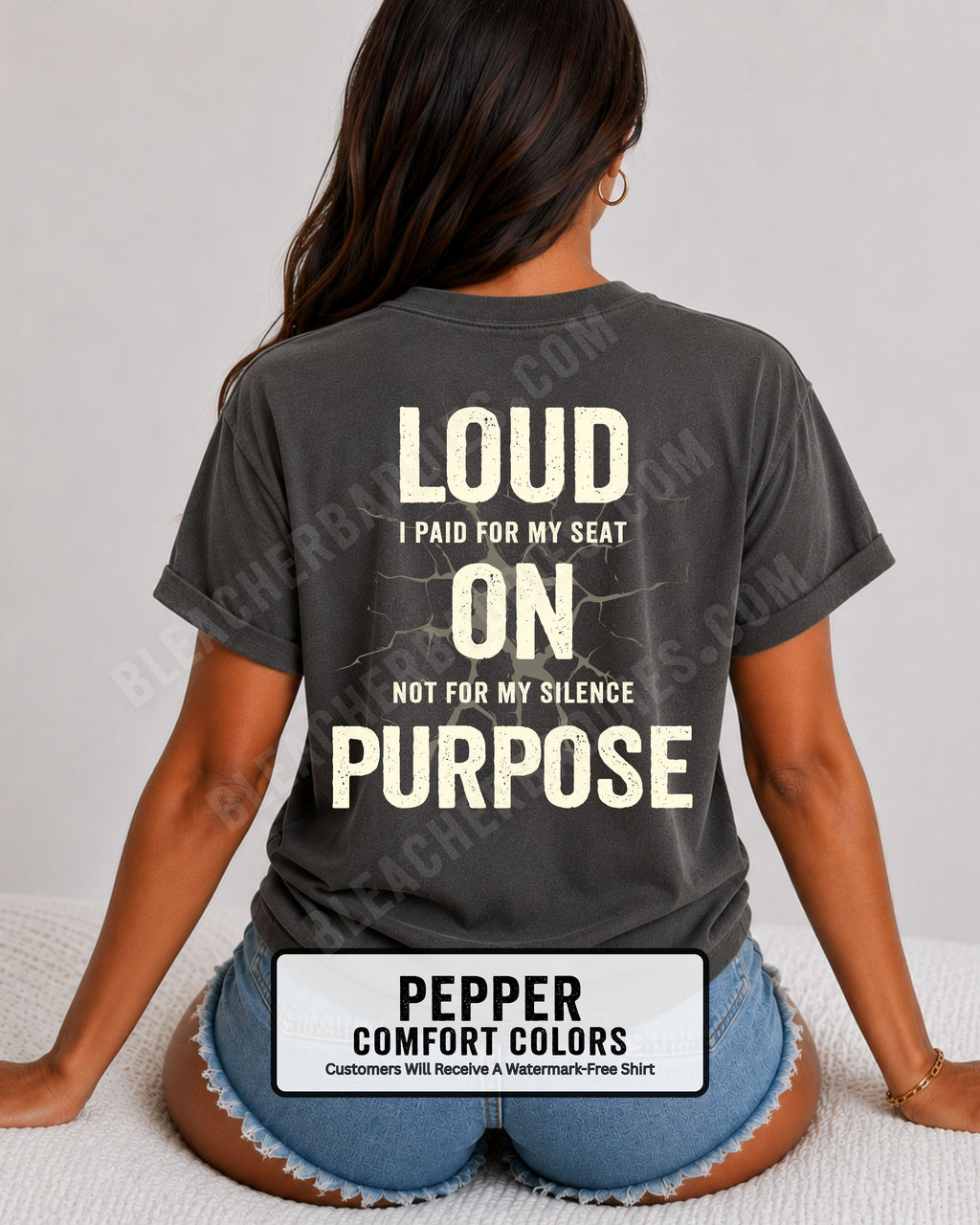 Woman wearing a pepper Comfort Colors t-shirt shown from the back featuring a large distressed cream graphic that reads “Loud I Paid for My Seat On Purpose Not For My Silence” with a cracked texture effect.