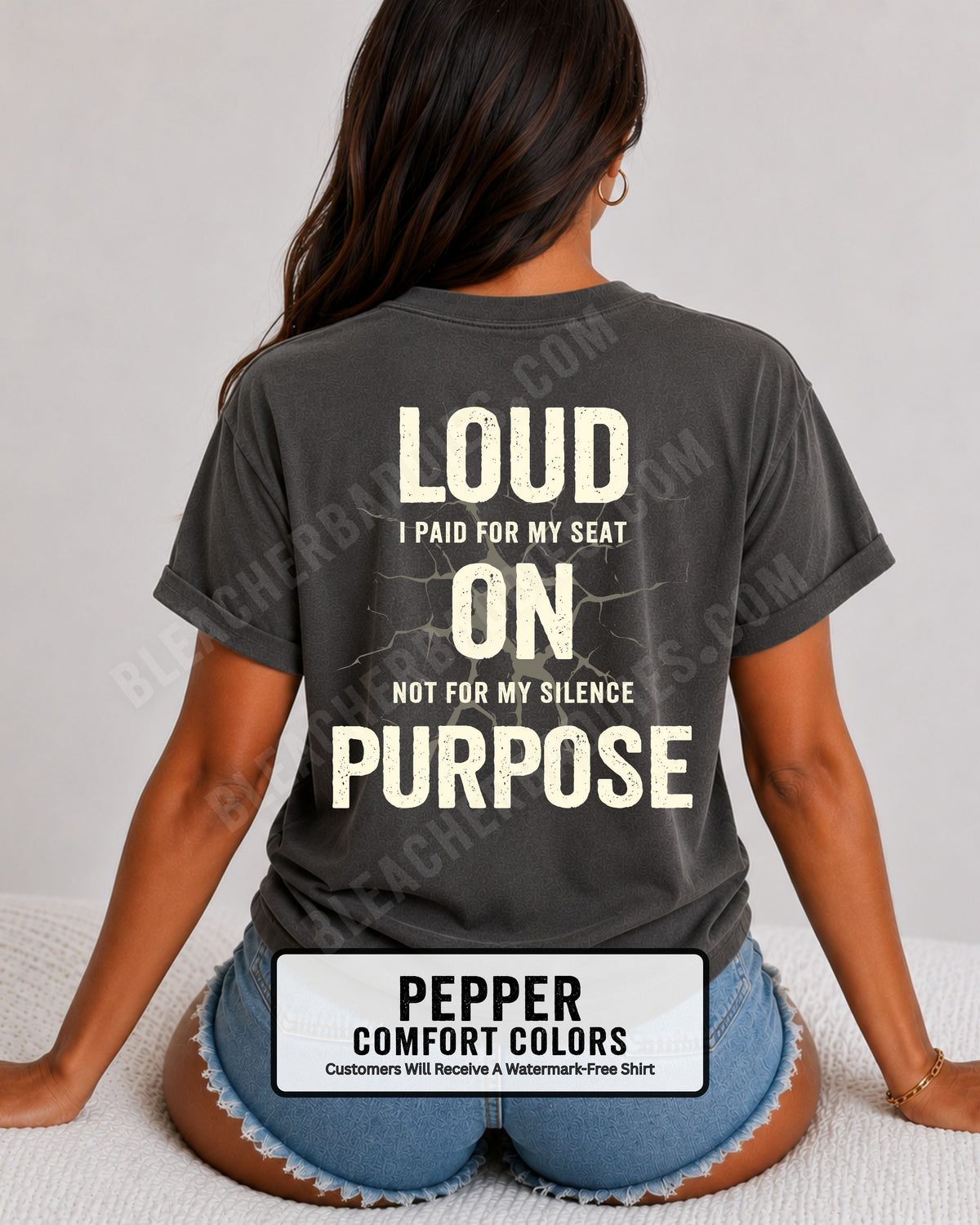 Woman wearing a pepper Comfort Colors t-shirt shown from the back featuring a large distressed cream graphic that reads “Loud I Paid for My Seat On Purpose Not For My Silence” with a cracked texture effect.