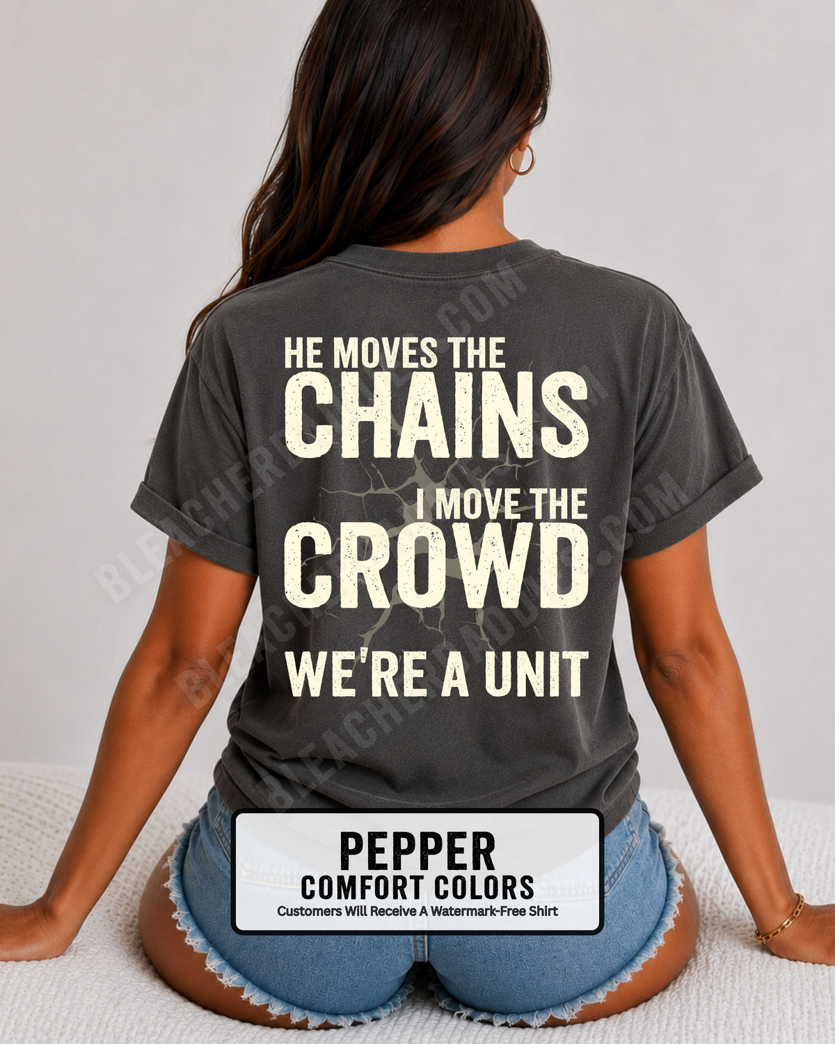 Back view of woman wearing pepper Comfort Colors football mom game day shirt featuring “He Moves the Chains I Move the Crowd We’re a Unit” bold graphic design