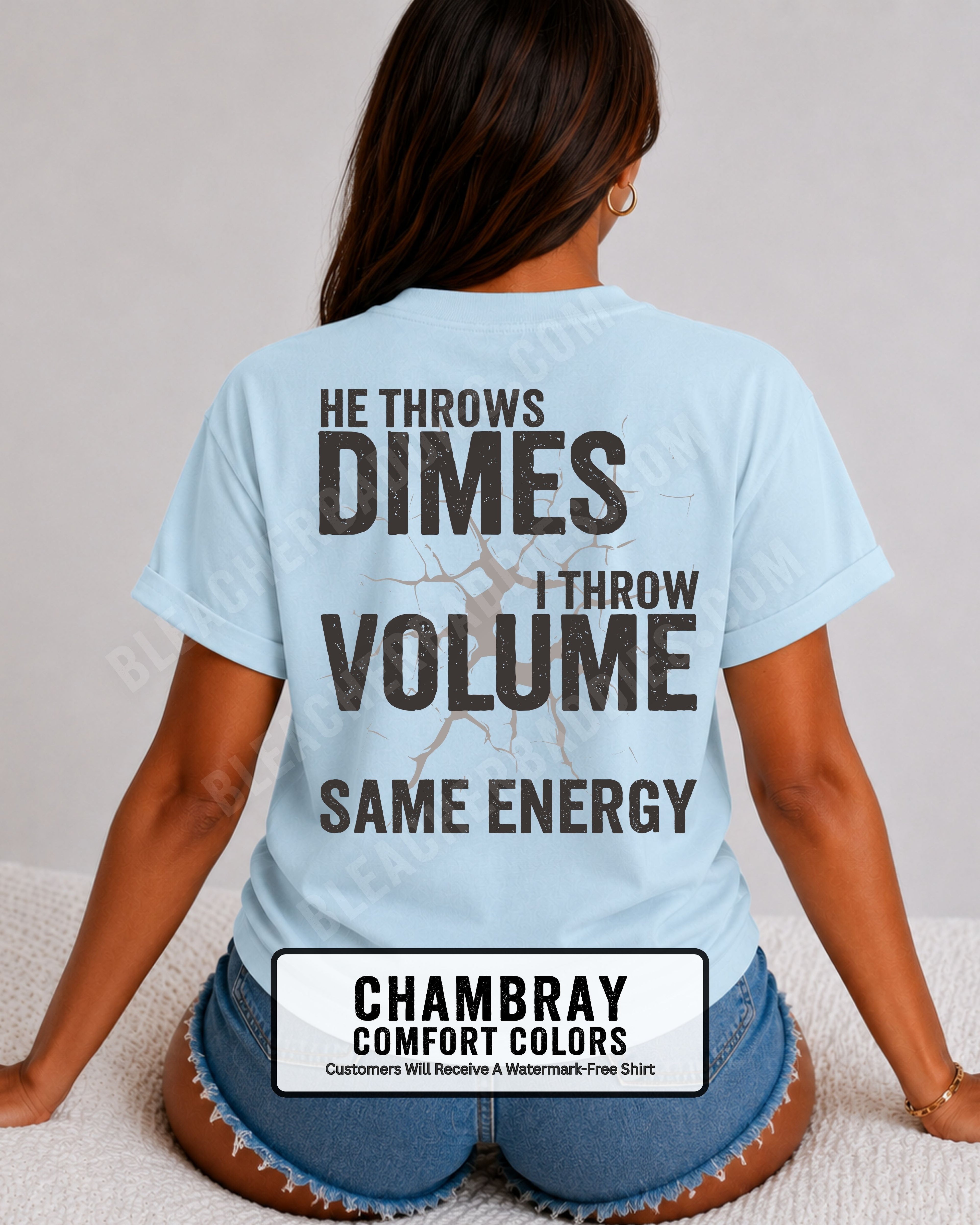Back view of woman wearing chambray Comfort Colors t-shirt mockup showing large distressed text “He Throws Dimes I Throw Volume Same Energy” centered on the back design. Quarterback mom shirt. Football mom shirt.