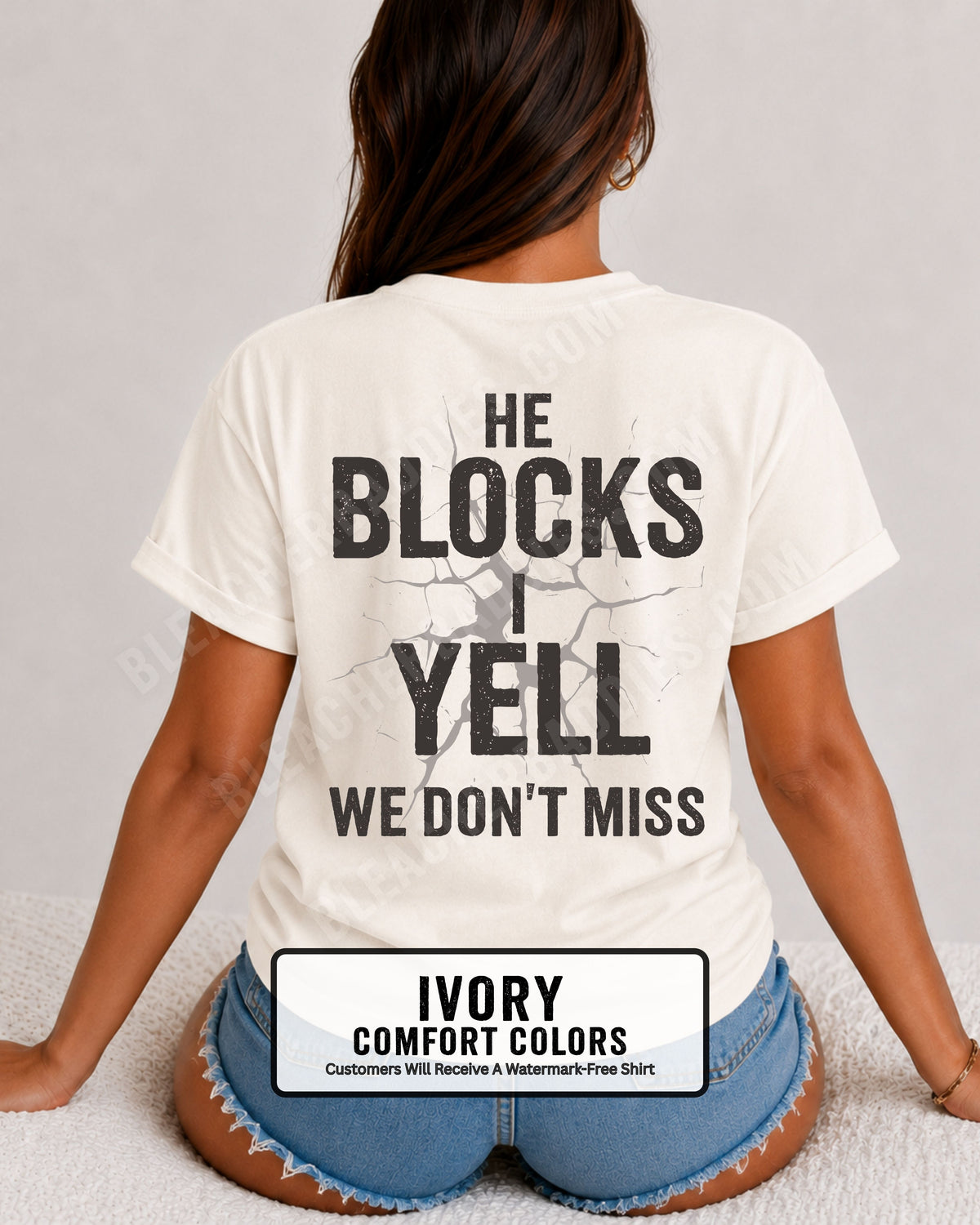Woman wearing ivory Comfort Colors football mom game day shirt with back design that reads “He blocks I yell we don’t miss” in distressed black text with cracked graphic