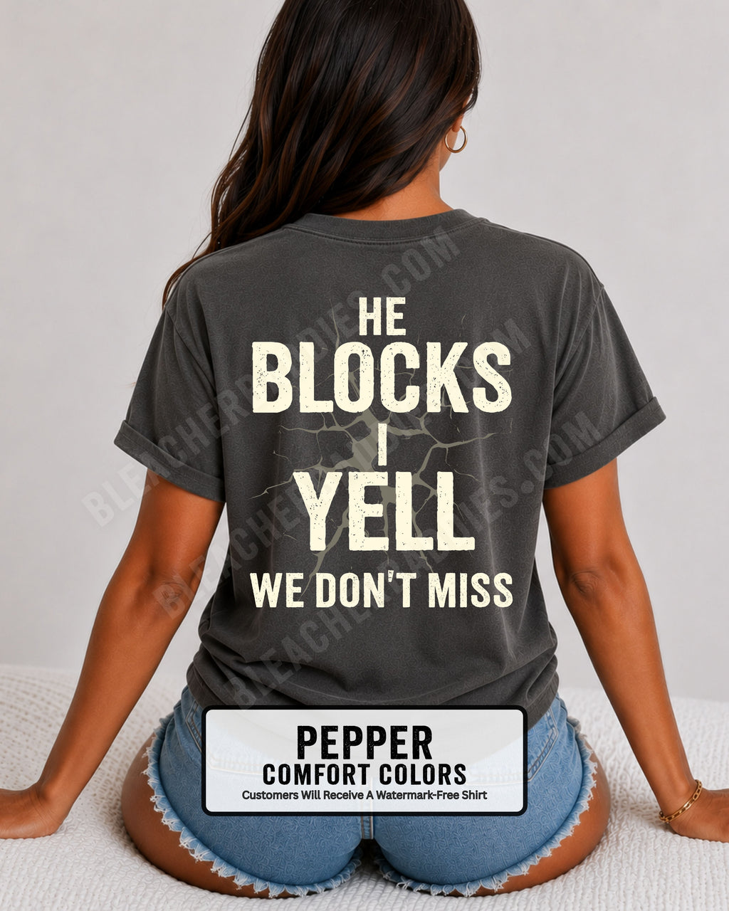 Woman wearing pepper Comfort Colors football mom game day shirt with back design that reads “He blocks I yell we don’t miss” in distressed black text with cracked graphic