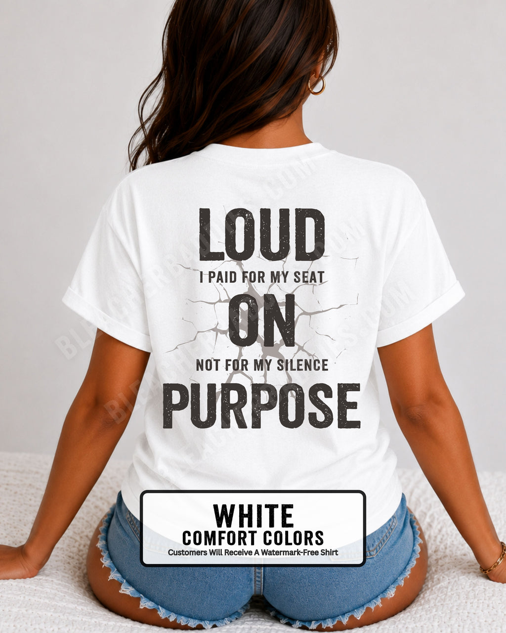 Woman wearing a white Comfort Colors t-shirt shown from the back featuring a large distressed black graphic that reads “Loud I Paid for My Seat On Purpose Not For My Silence” with a cracked texture effect.