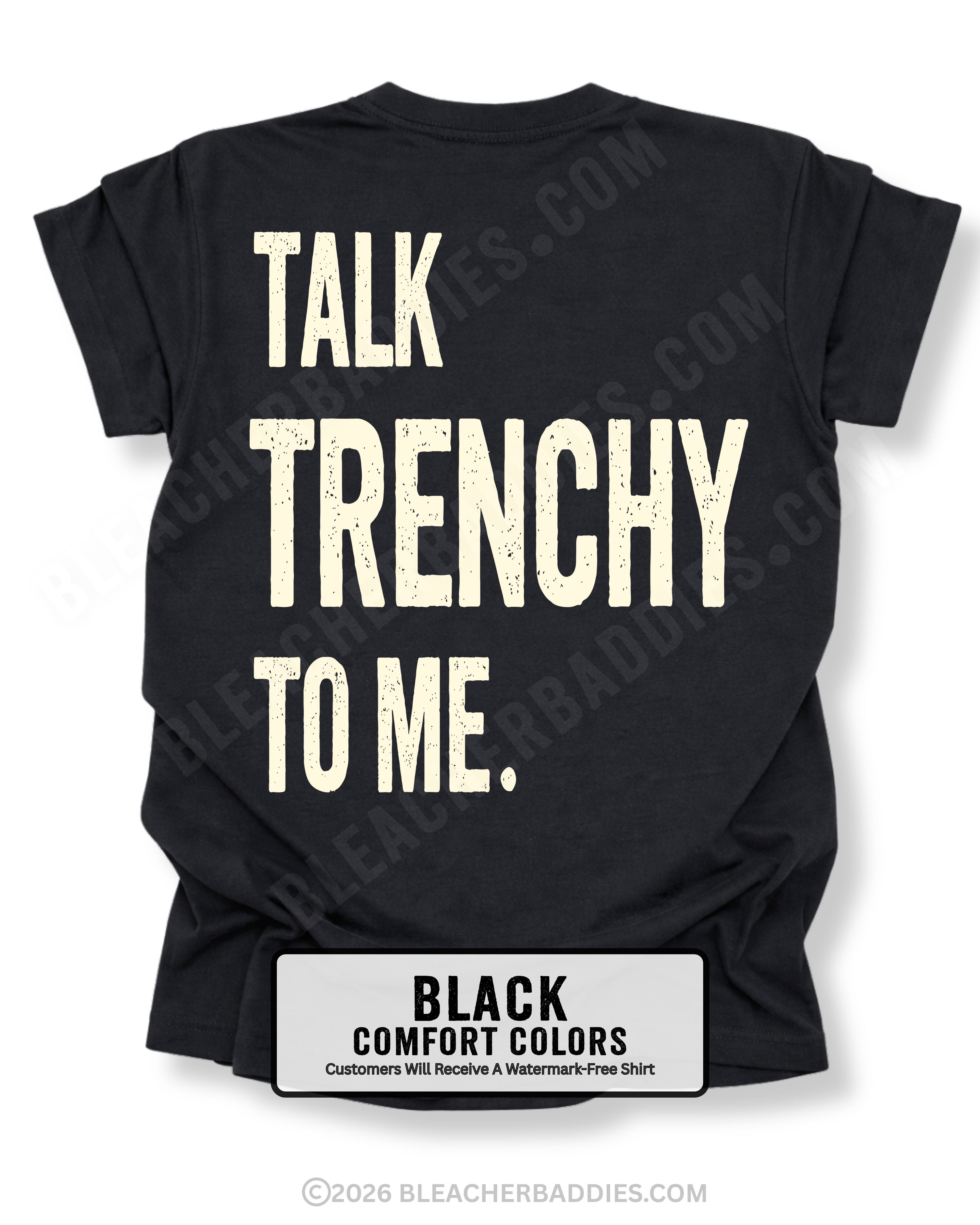 Black Comfort Colors T-shirt featuring the funny football back design "Talk Trenchy to Me" in distressed cream lettering. Flat lay mockup showcasing a humorous offensive line fan shirt perfect for football moms, dads, tailgates, Friday night lights, and game day.