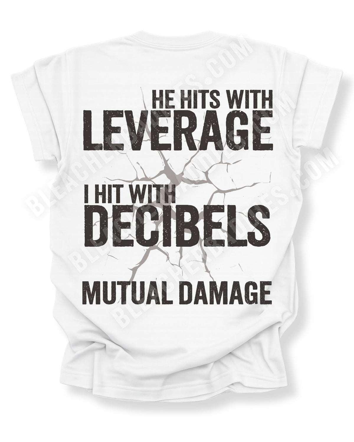 Flat lay of a white Comfort Colors t-shirt featuring the phrase "He Hits with Leverage, I Hit with Decibels" and "Mutual Damage" in a distressed football-inspired design on the back. Football mom shirt. Lineman mom shirt. Linebacker mom shirt. 