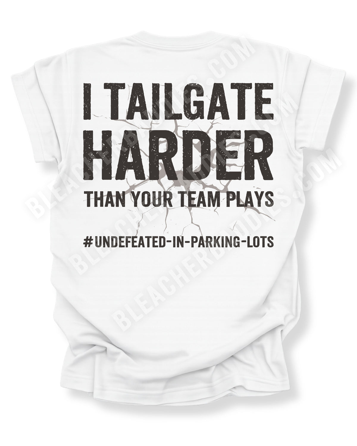 White Comfort Colors football mom game day shirt flat lay with back design that reads “I tailgate harder than your team plays #undefeated-in-parking-lots” in distressed black text with cracked graphic. Football mom shirt. Tailgating football fan shirt.