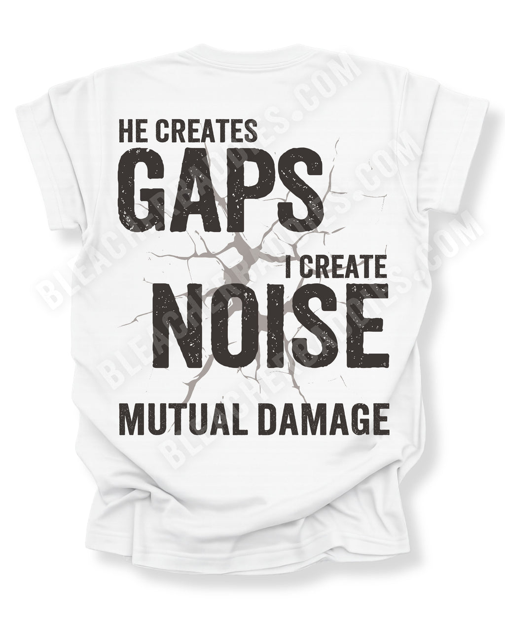 White Comfort Colors football mom game day shirt flat lay with back design that reads “He creates gaps I create noise mutual damage” in distressed black text with cracked impact graphic. Offensive lineman mom shirt. Football mom shirt.