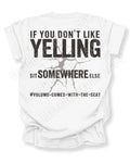 White t-shirt shown from the back featuring a large distressed black graphic that reads “If You Don’t Like Yelling Sit Somewhere Else #Volume Comes With the Seat” with a cracked texture effect. Football mom shirt. Lineman mom shirt. Running back mom shirt. Quarterback mom shirt Linebacker mom shirt.