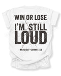 White t-shirt shown from the back featuring a large distressed black graphic that reads “Win or Lose I’m Still Loud #Audibly Committed” with a cracked texture effect. Football mom shirt. Running back mom shirt. Lineman mom shirt. Wide Receiver mom shirt.