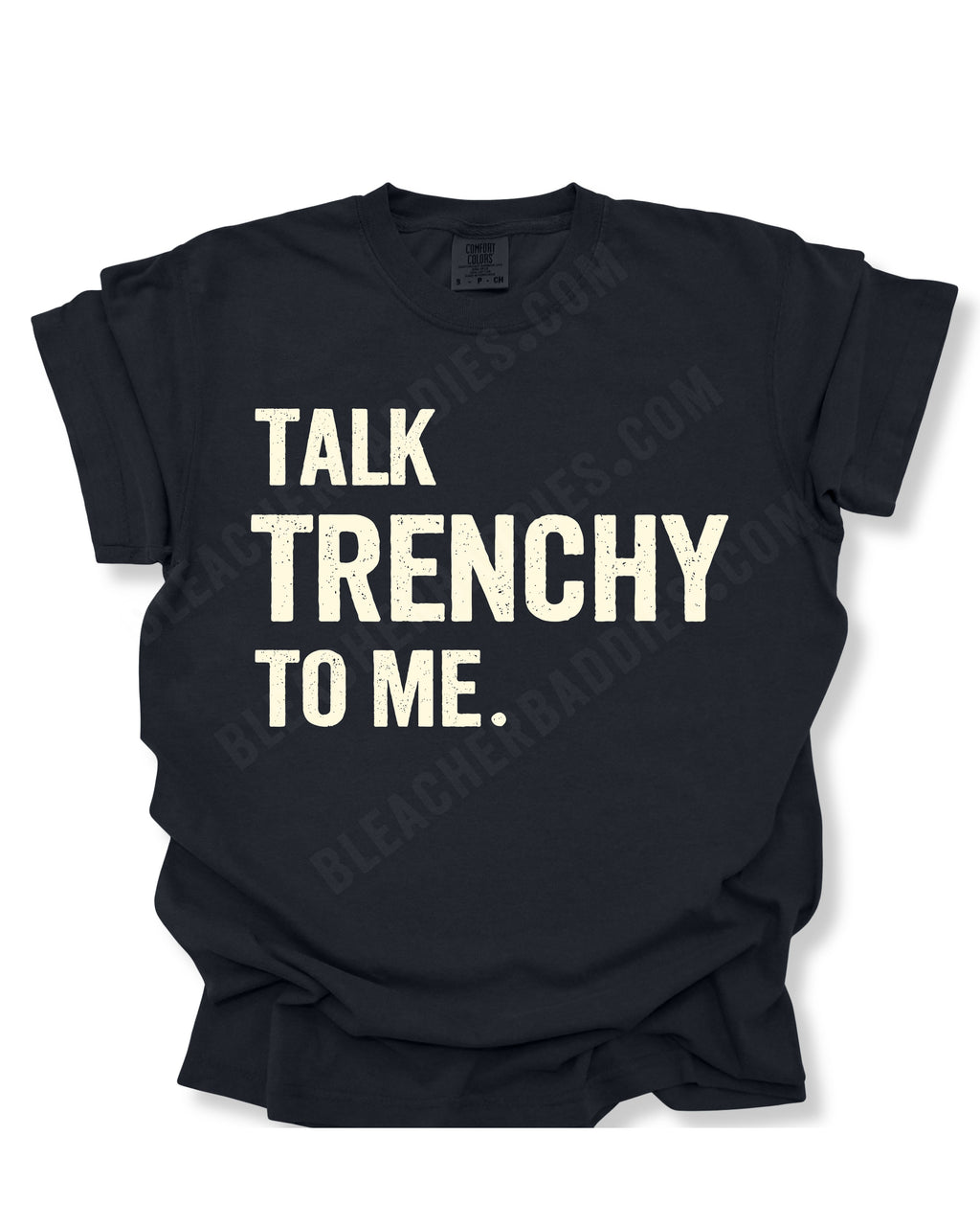 Flat lay of a black Comfort Colors t-shirt featuring the distressed ivory text "TALK TRENCHY TO ME." in large block letters. The shirt is displayed on a white background with rolled sleeves, showcasing a bold football offensive line-inspired graphic perfect for linemen, football players, coaches, and trench football fans.