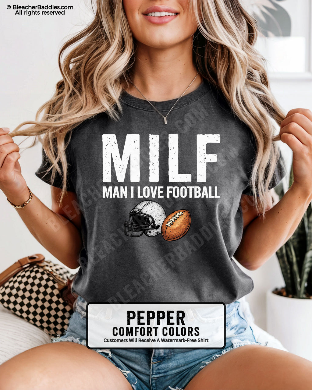 Woman wearing pepper comfort colors t-shirt that says “MILF Man I Love Football” with football helmet and ball graphic