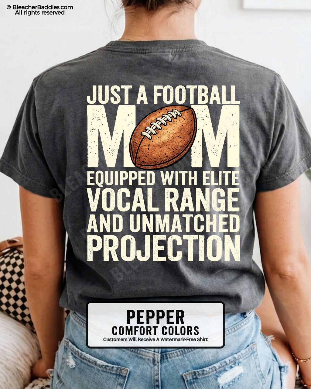 Football mom game day shirt on a pepper Comfort Colors tee, featuring a back graphic that says, “Just a football mom equipped with elite vocal range and unmatched projection.”