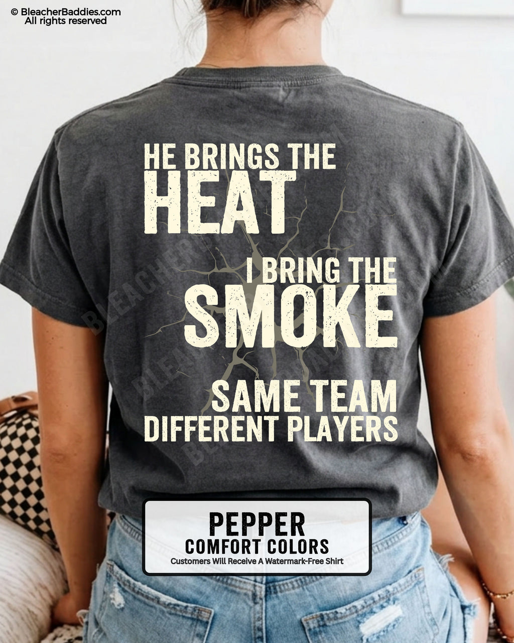 Close-up of PEPPER COMFORT COLORS FOOTBALL MOM t-shirt back print showing distressed text “He Brings the Heat I Bring the Smoke Same Team Different Players” with cracked design detail