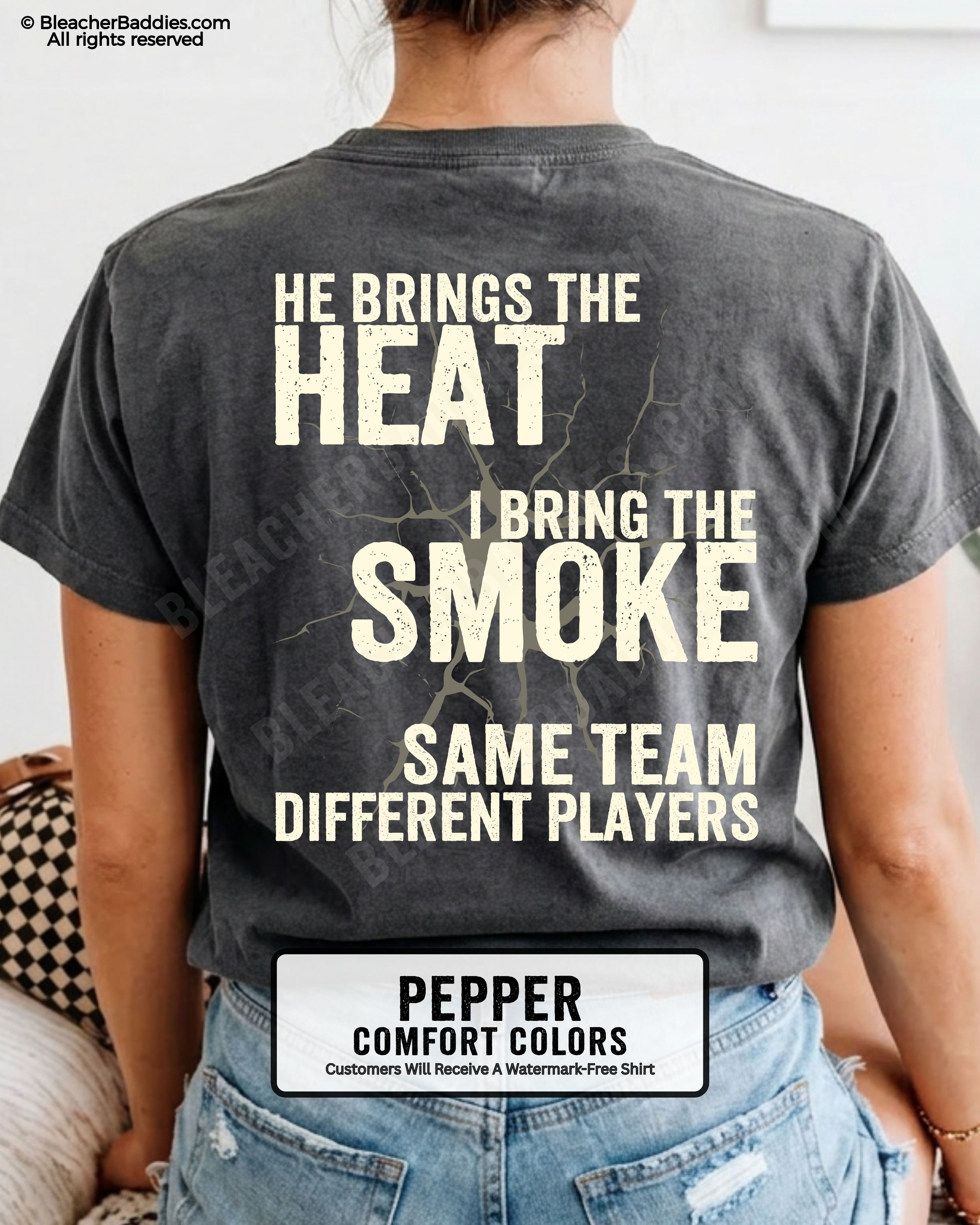 Close-up of PEPPER COMFORT COLORS FOOTBALL MOM t-shirt back print showing distressed text “He Brings the Heat I Bring the Smoke Same Team Different Players” with cracked design detail
