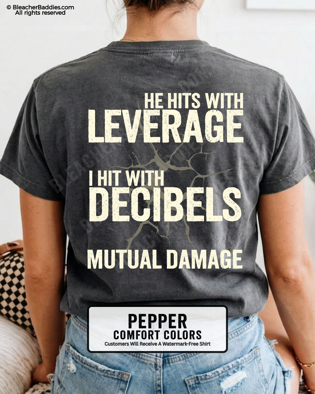Back view of a pepper Comfort Colors football mom t-shirt featuring the "He Hits with Leverage, I Hit with Decibels" graphic and "Mutual Damage" printed in a distressed game day design.