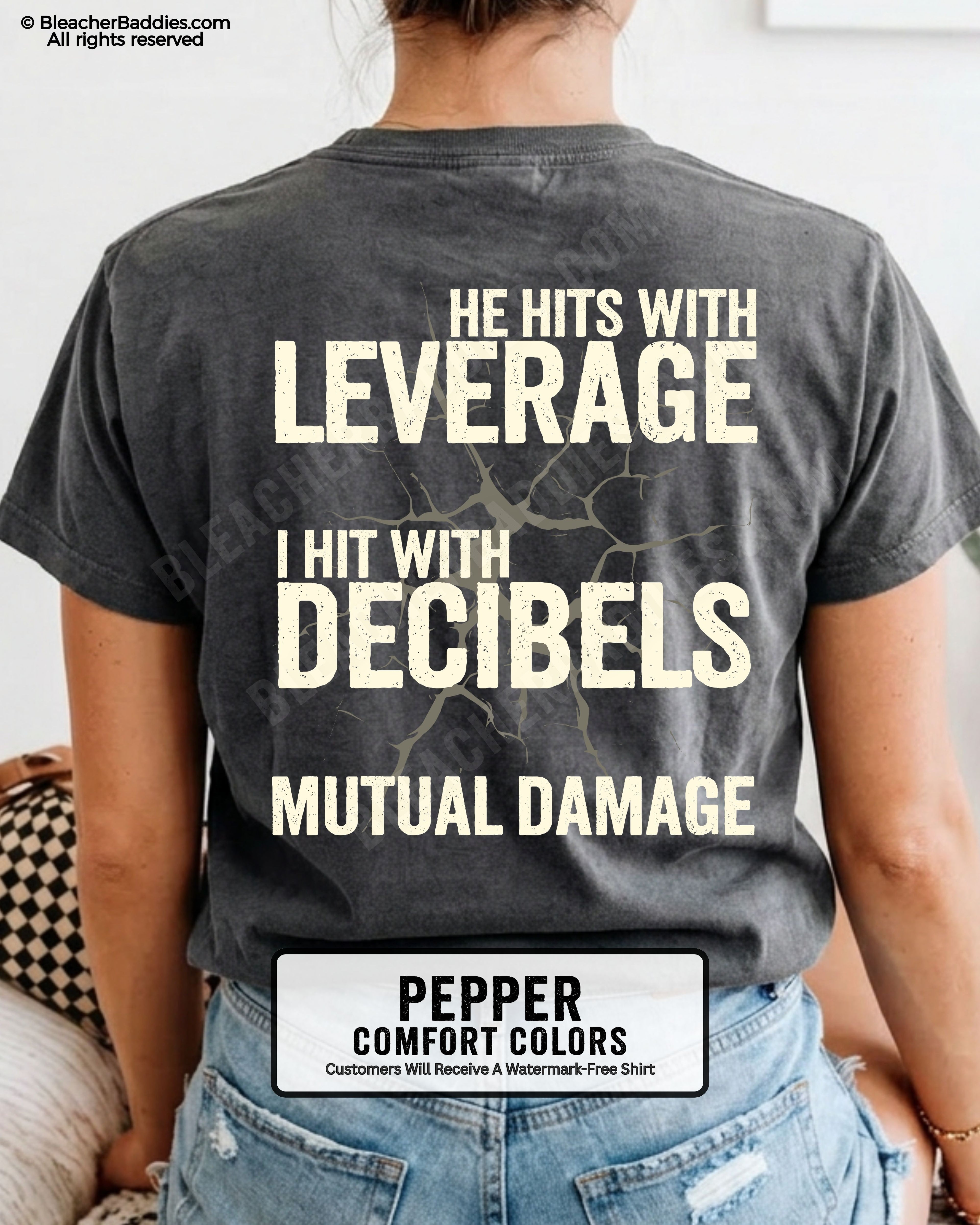 Back view of a pepper Comfort Colors football mom t-shirt featuring the "He Hits with Leverage, I Hit with Decibels" graphic and "Mutual Damage" printed in a distressed game day design.
