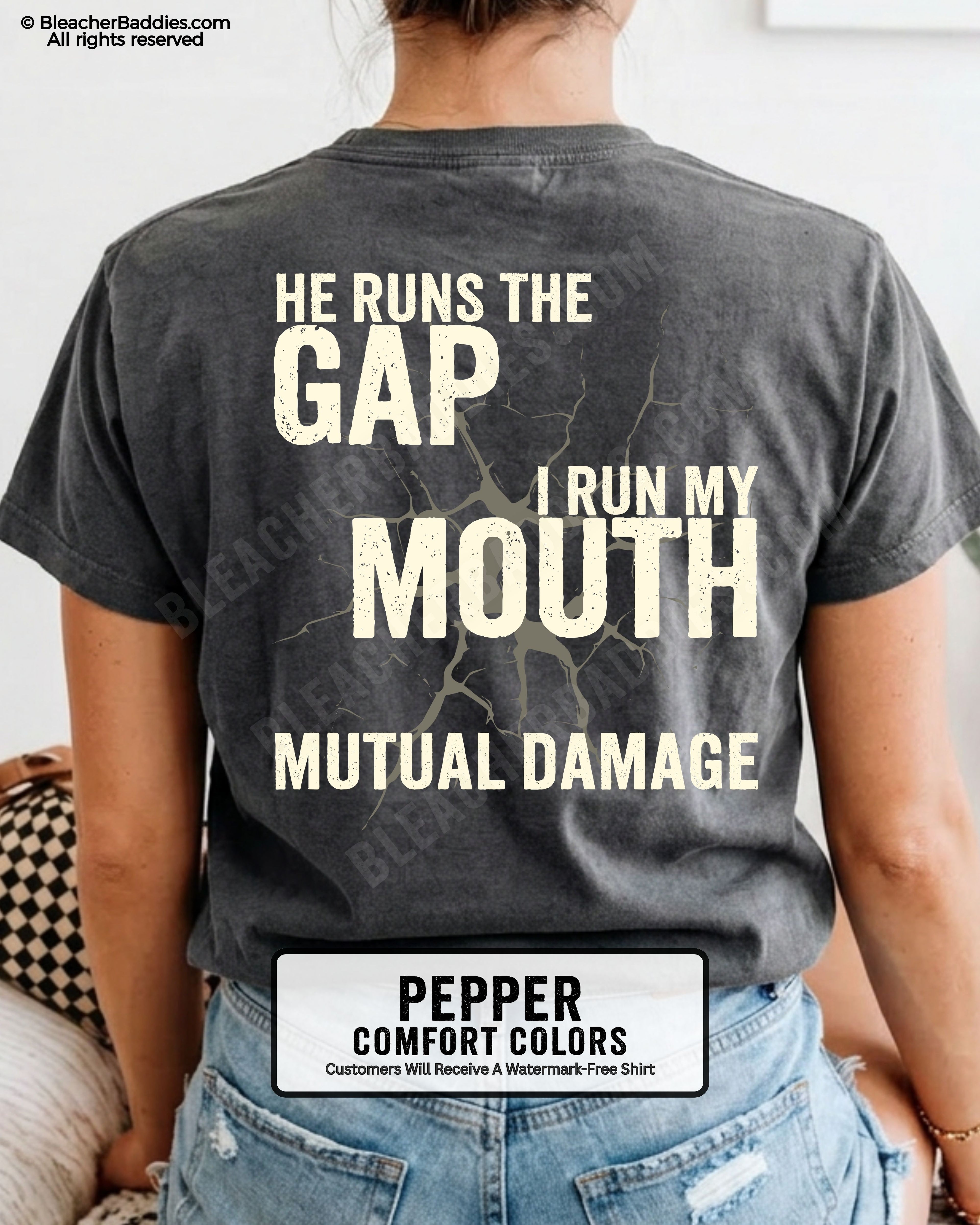 Back view of football mom wearing pepper Comfort Colors game day shirt with “He Runs the Gap I Run My Mouth Mutual Damage” graphic design