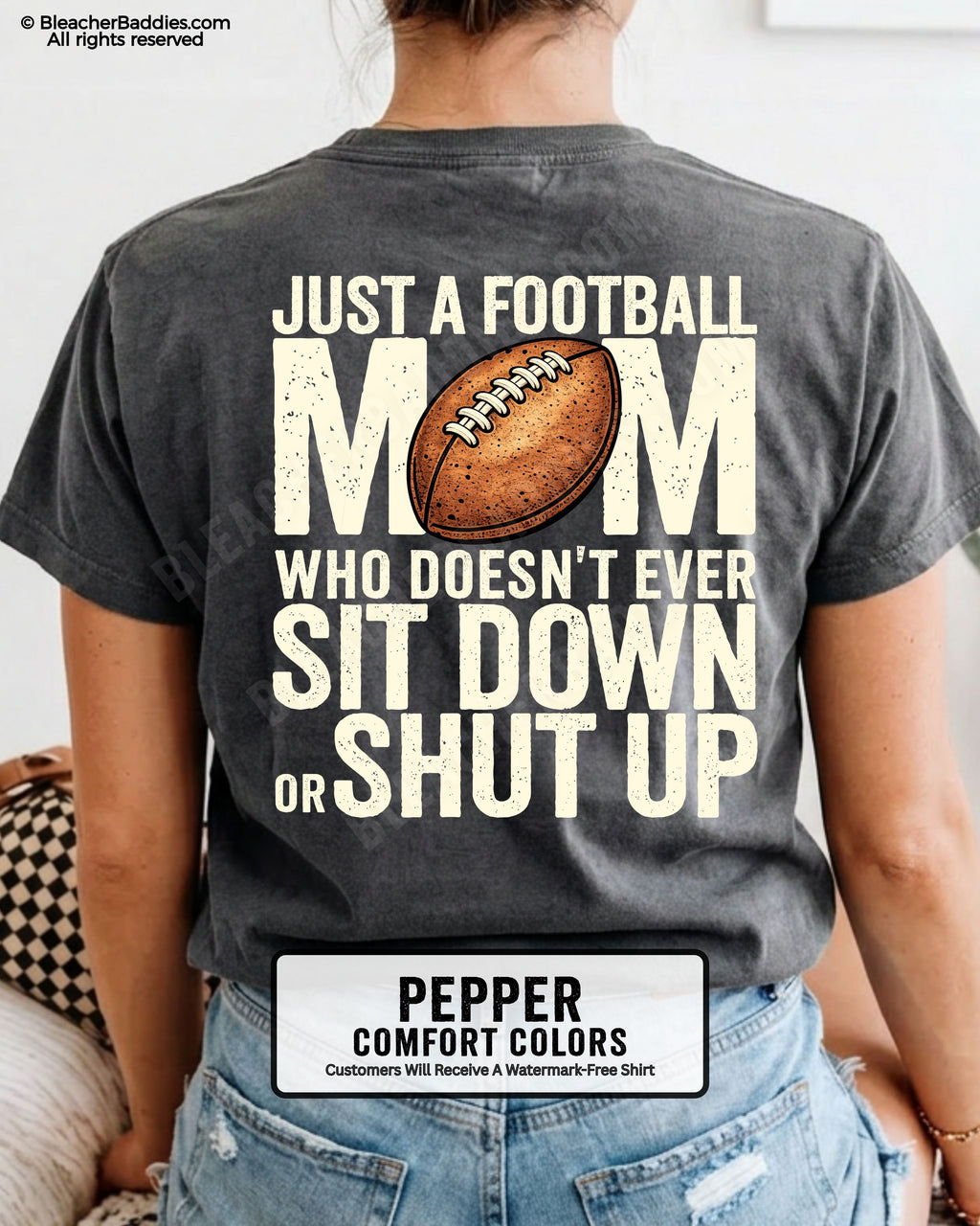 Pepper Comfort Colors t-shirt shown from back with oversized graphic text “Just a Football Mom Who Doesn’t Ever Sit Down or Shut Up” and football illustration