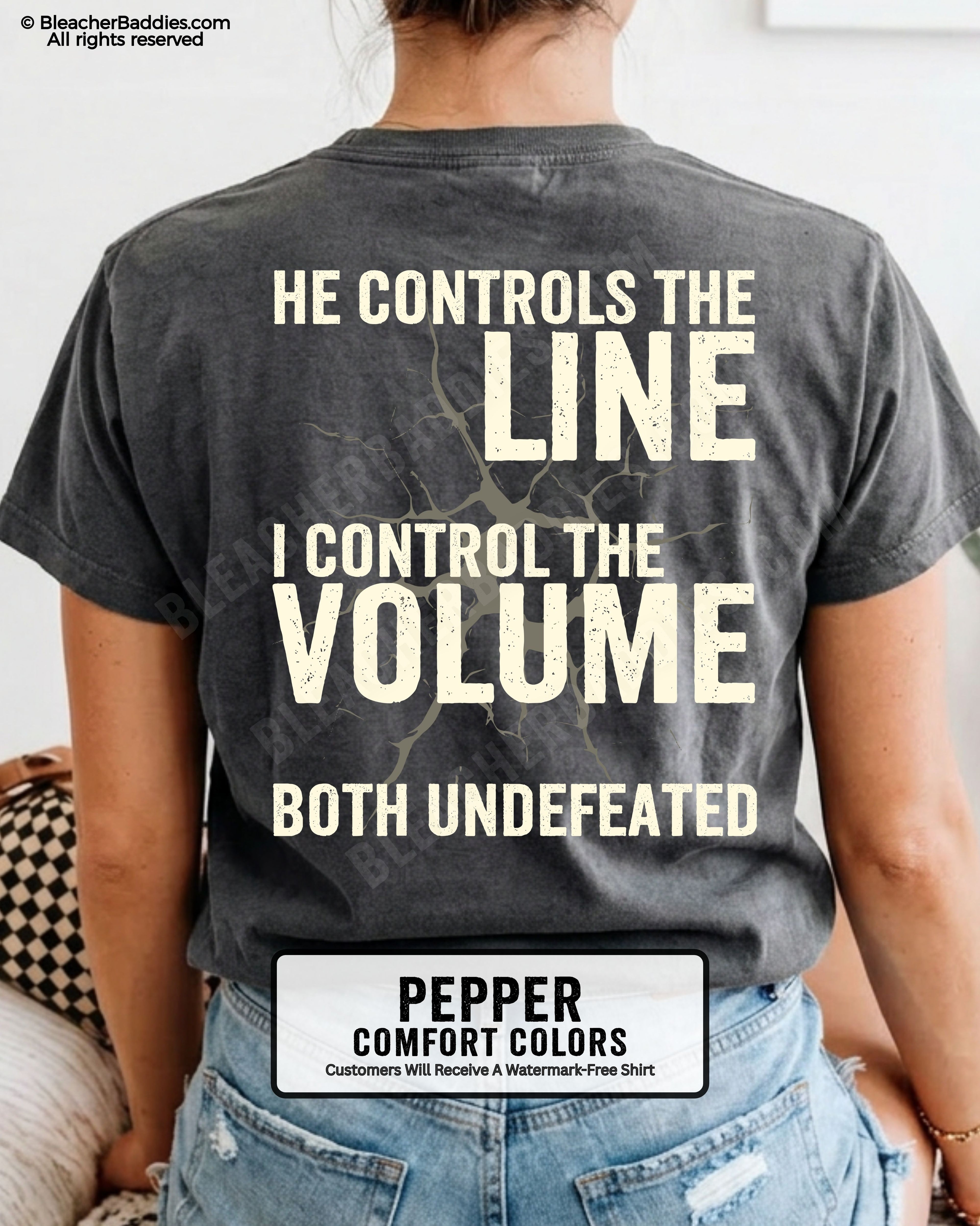 Back view of woman wearing PEPPER Comfort Colors football mom game day shirt featuring “He Controls the Line I Control the Volume Both Undefeated” bold graphic design