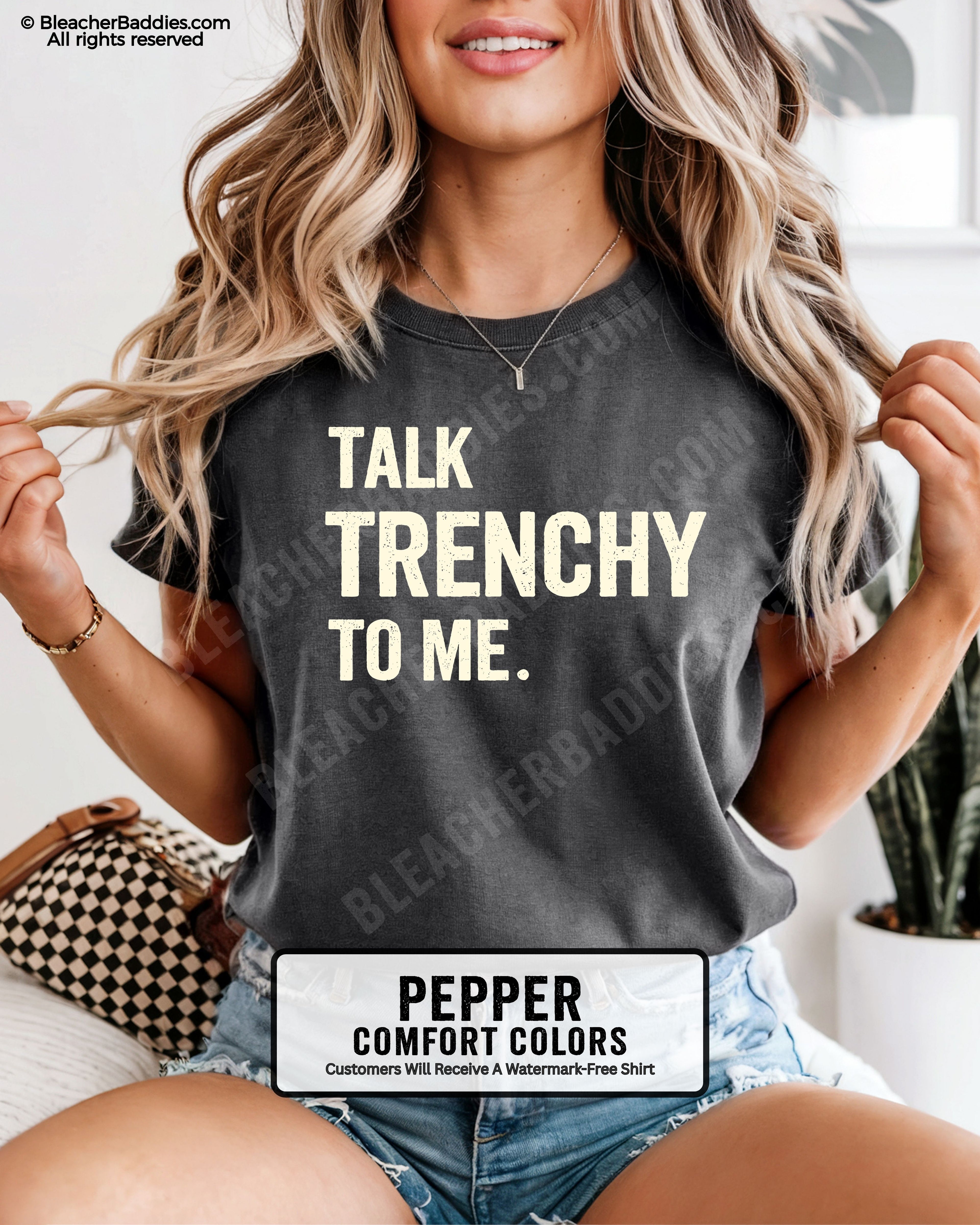 Model wearing pepper Comfort Colors t-shirt featuring the phrase "Talk Trenchy To Me." in distressed lettering. Funny football lineman shirt for offensive line fans, football moms, game day, tailgates, and Friday night lights.