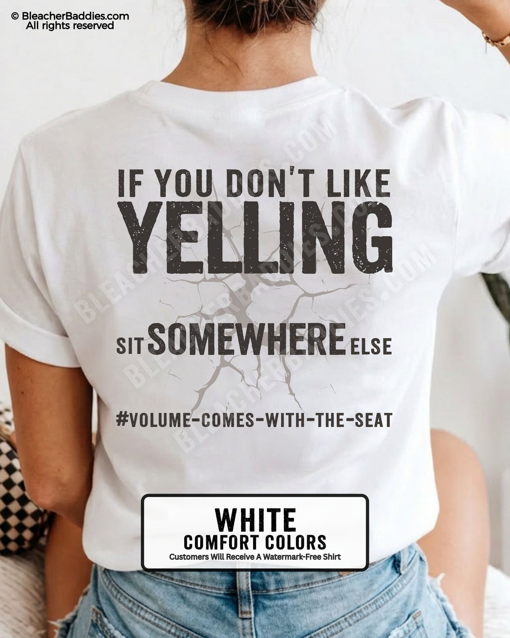 Woman wearing a white Comfort Colors t-shirt shown from the back featuring a large distressed black graphic that reads “If You Don’t Like Yelling Sit Somewhere Else #Volume Comes With the Seat.”