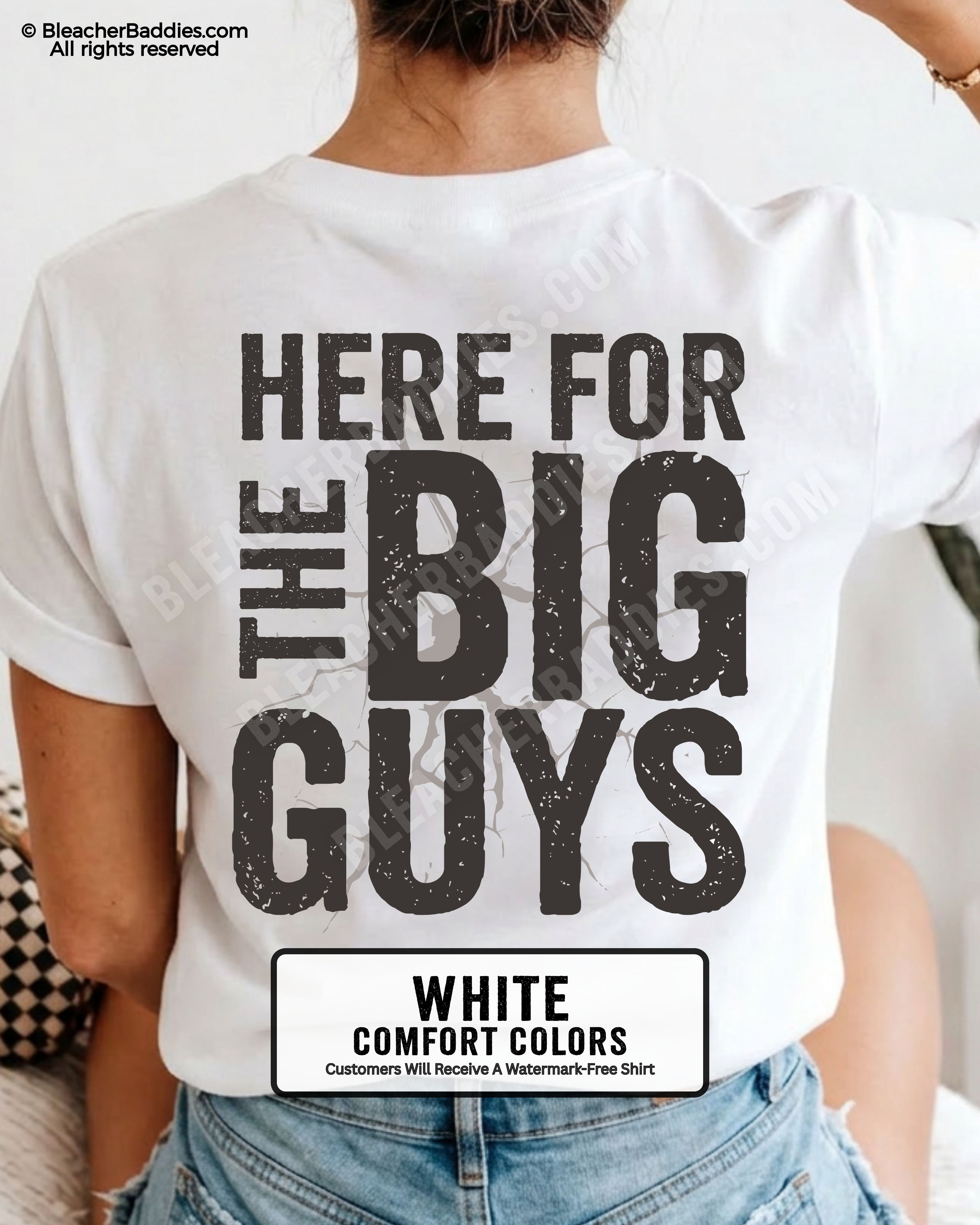 Close-up of football mom wearing a white comfort colors game day shirt showing distressed black text “Here for the big guys” with cracked effect graphic behind lettering