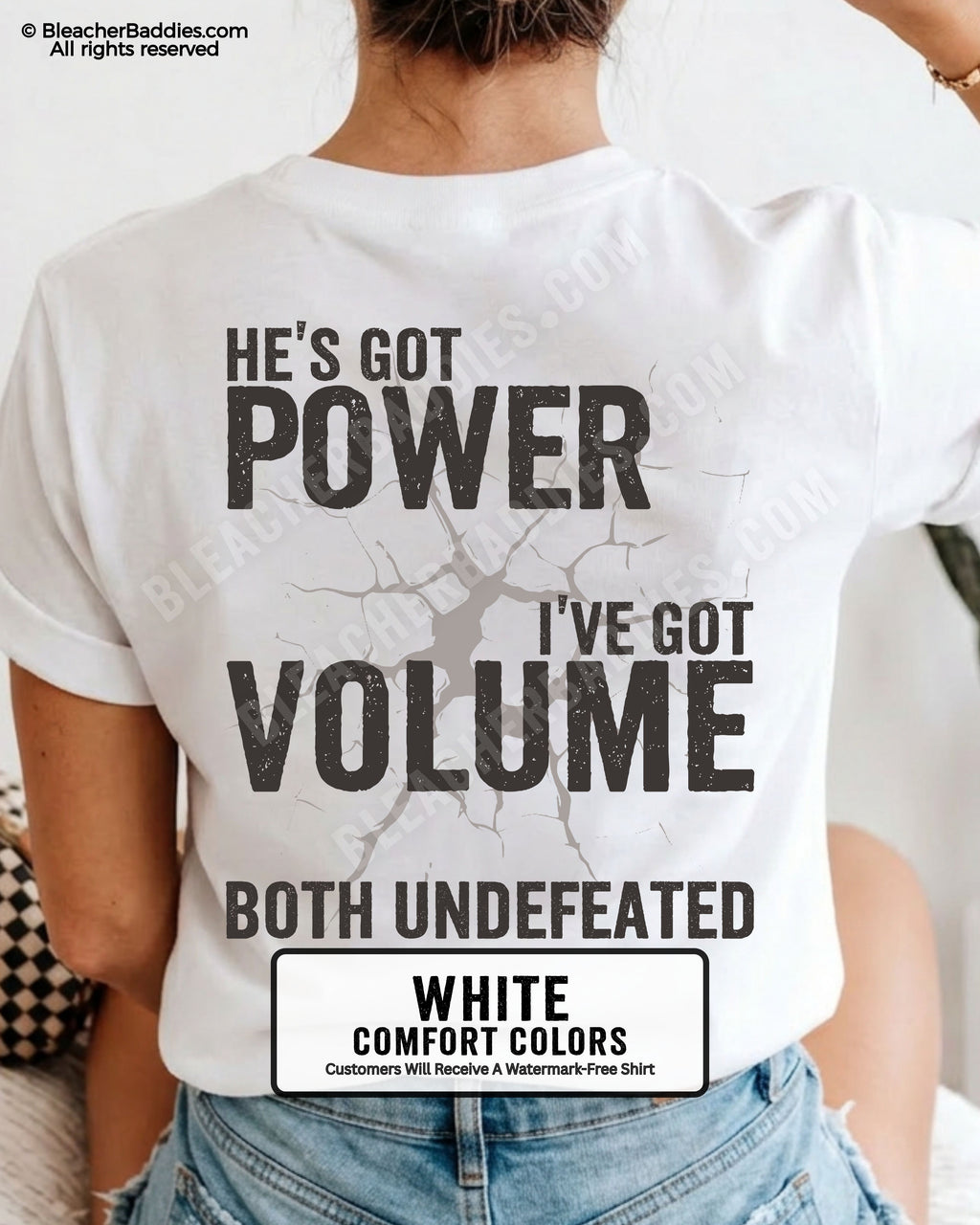 Back view of WHITE Comfort Colors football mom game day shirt reading “He’s Got Power I’ve Got Volume Both Undefeated,” close-up fit on woman wearing denim shorts