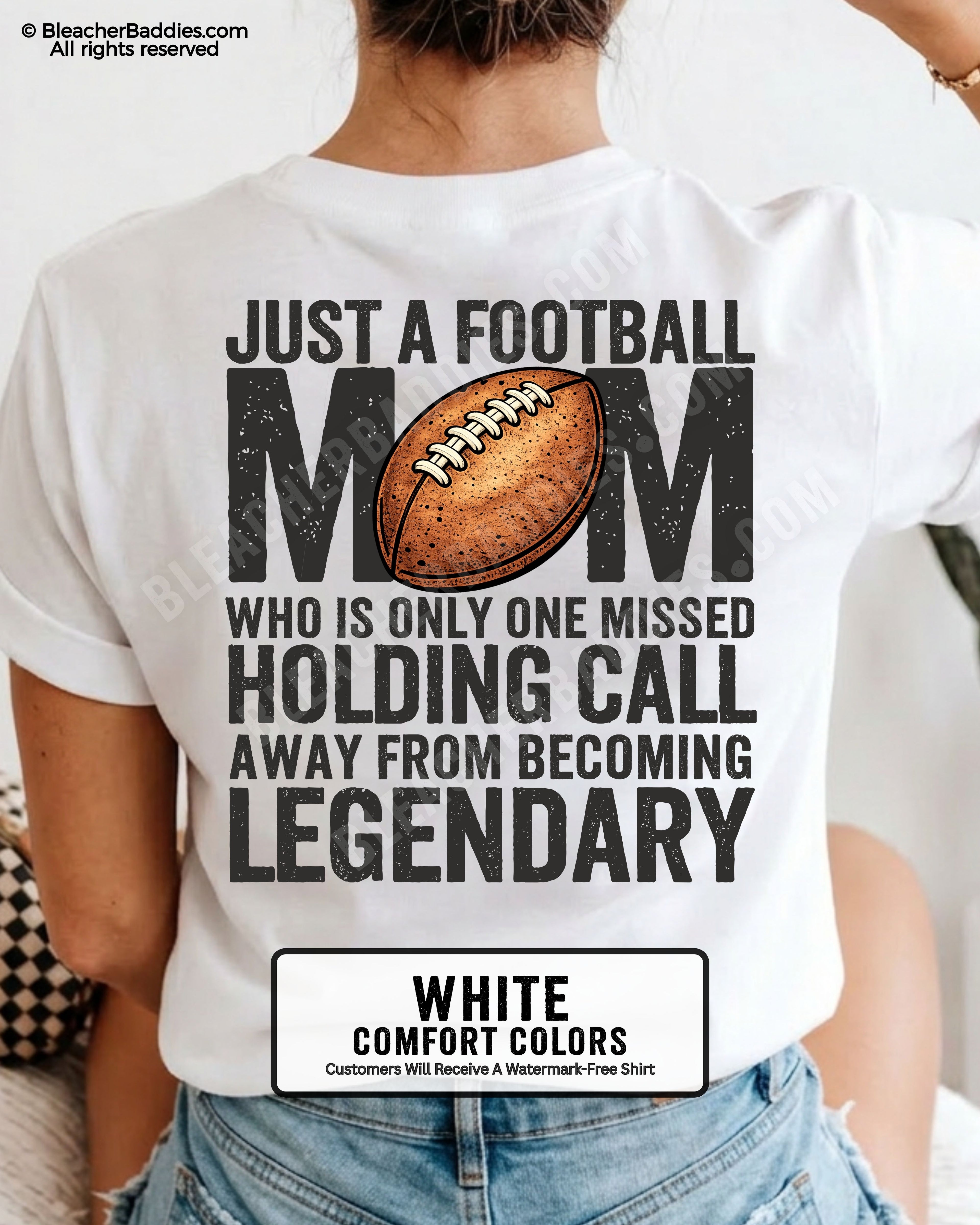 Woman wearing white Comfort Colors t-shirt showing back graphic reading “Just a football mom who is only one missed holding call away from becoming legendary” with football design