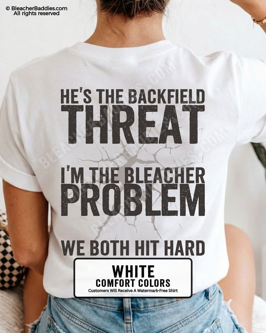 Back view of football mom wearing white Comfort Colors game day shirt with “He’s the Backfield Threat I’m the Bleacher Problem We Both Hit Hard” graphic design