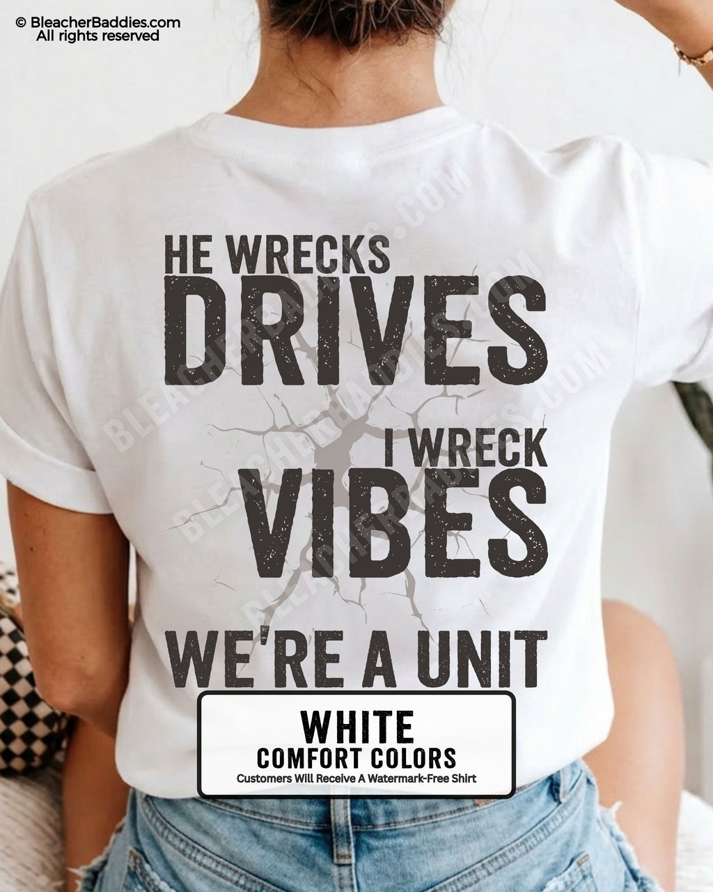 Woman wearing a white Comfort Colors t-shirt shown from the back featuring a large distressed black graphic that reads “He Wrecks Drives I Wreck Vibes We’re a Unit.”