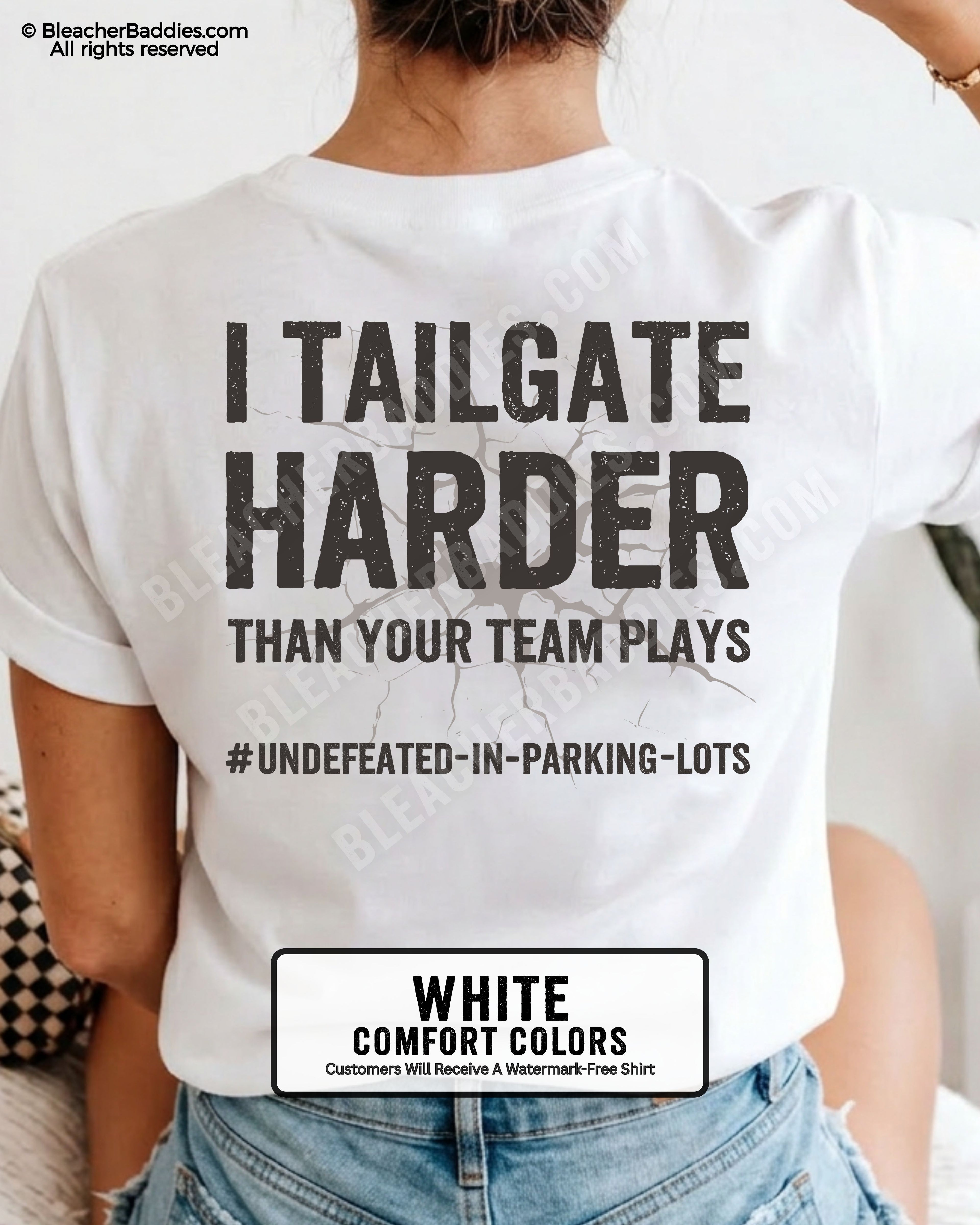 Woman wearing WHITE Comfort Colors football mom game day shirt with back design that reads “I tailgate harder than your team plays #undefeated-in-parking-lots” in distressed black text with cracked graphic and chambray color label shown