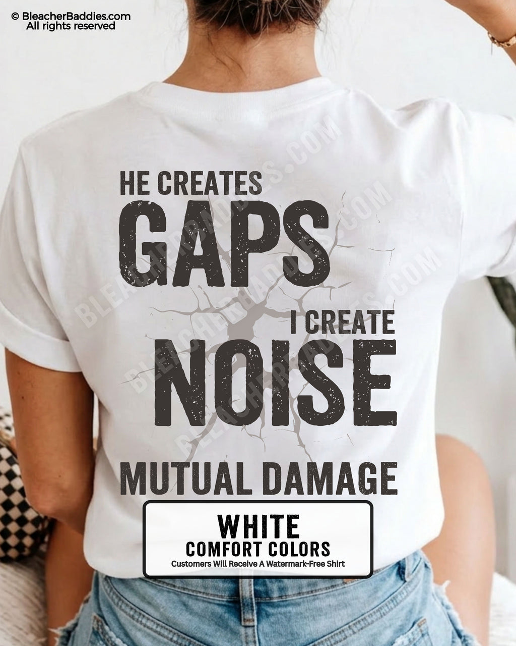 Woman wearing WHITE Comfort Colors football mom game day shirt with back design that reads “He creates gaps I create noise mutual damage” in distressed black text with cracked graphic and chambray color label shown